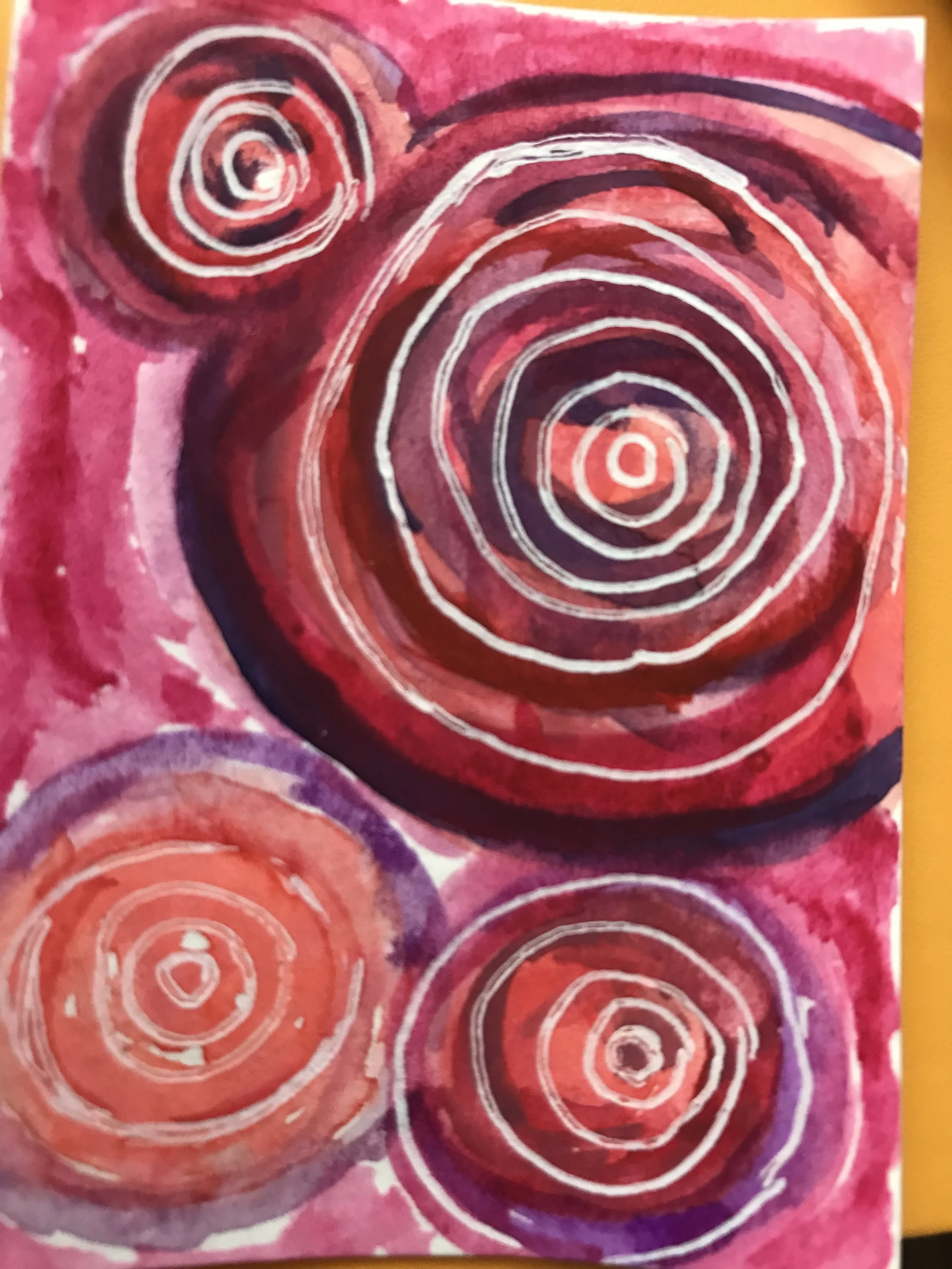Abstract painting featuring concentric circles in shades of red, pink, purple, and white, with a swirling pattern.