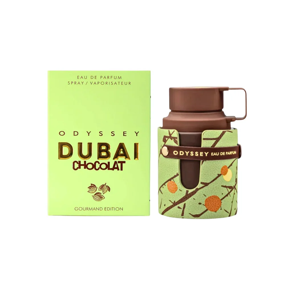 A perfume bottle with a green floral wrap and brown cap, beside a matching box labeled 'Odyssey Dubai Chocolat Eau de Parfum' with green and brown packaging design.