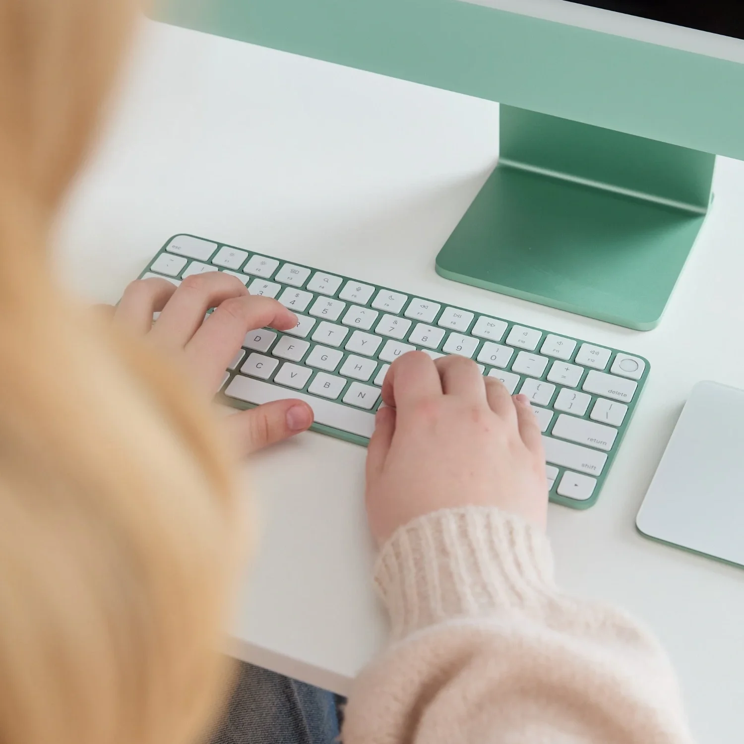Abby of Figment Branding typing on a green keyboard.