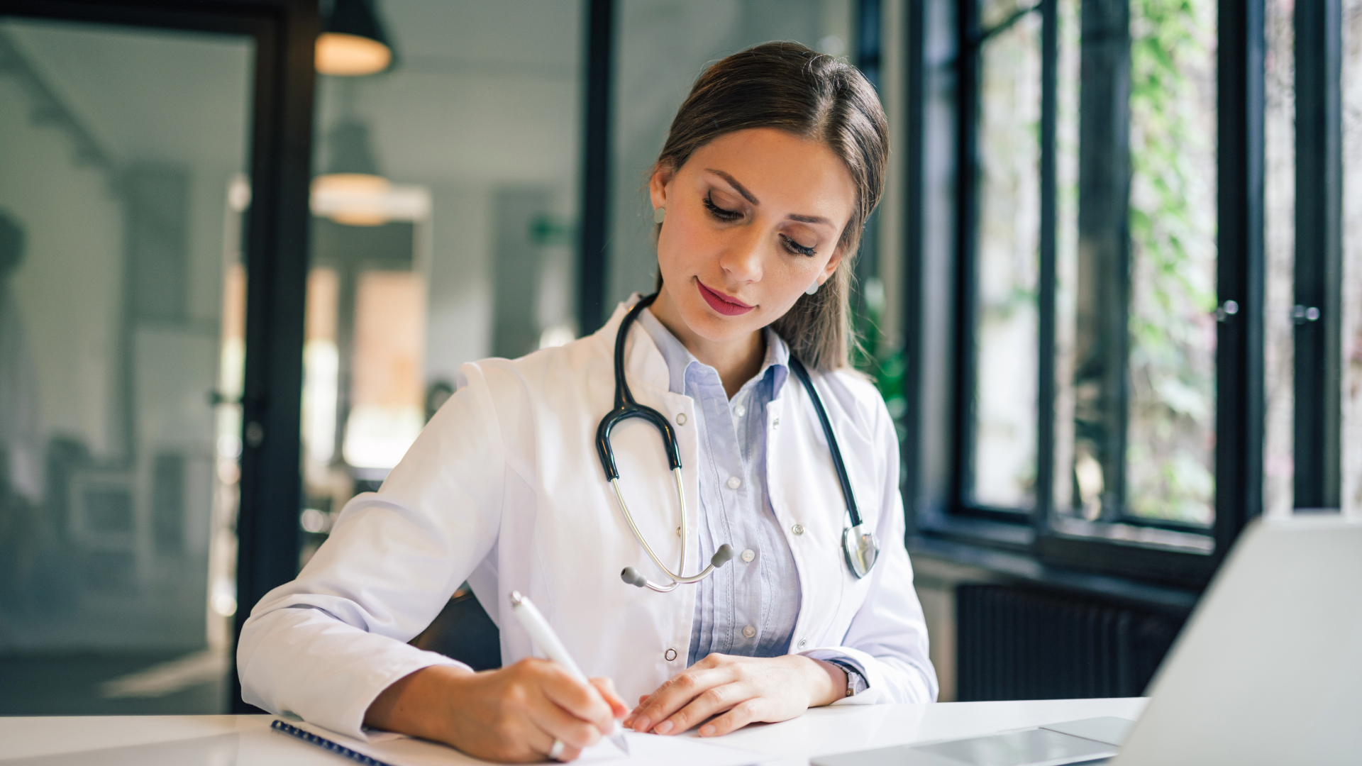 female doctor writing with a pen