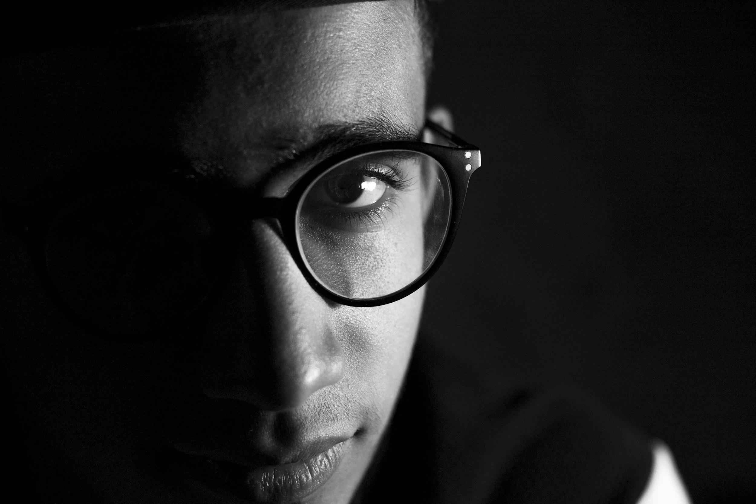 close up black and white photo of man with black eyeglasses