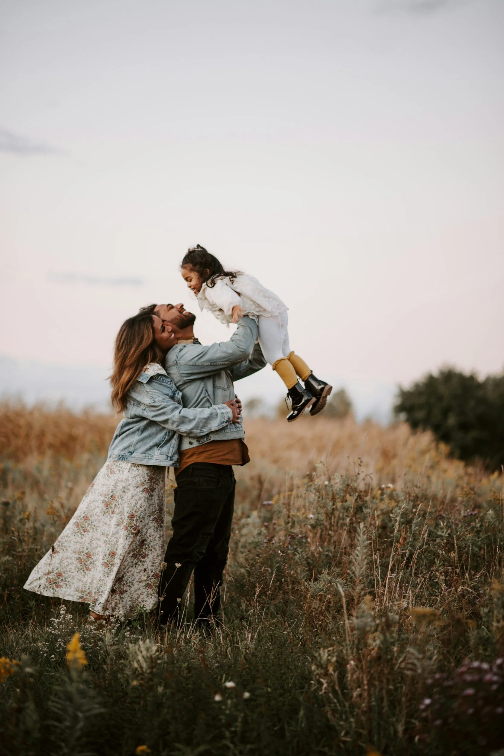 young family in field with child