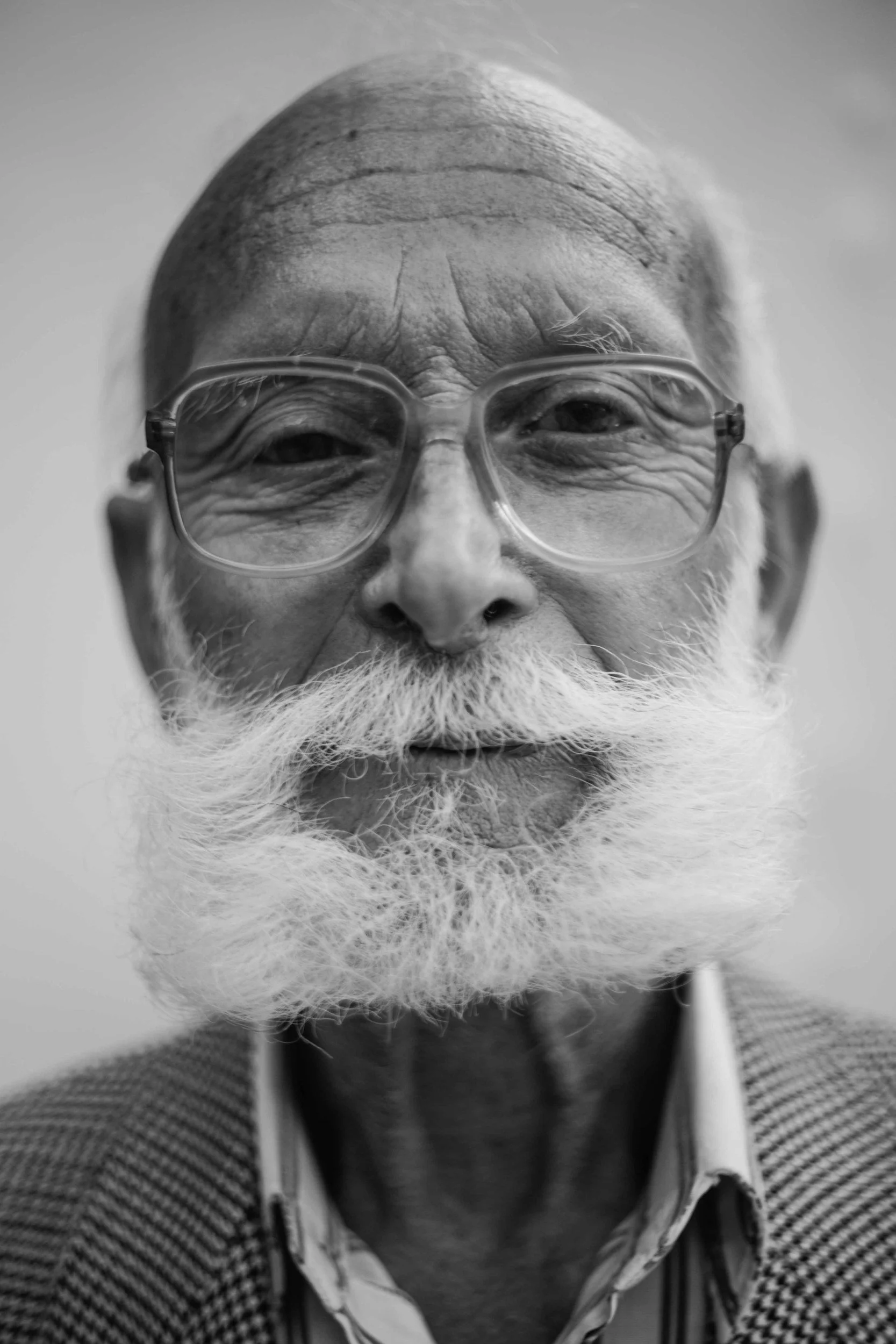 elderly man with eyeglasses and a white beard