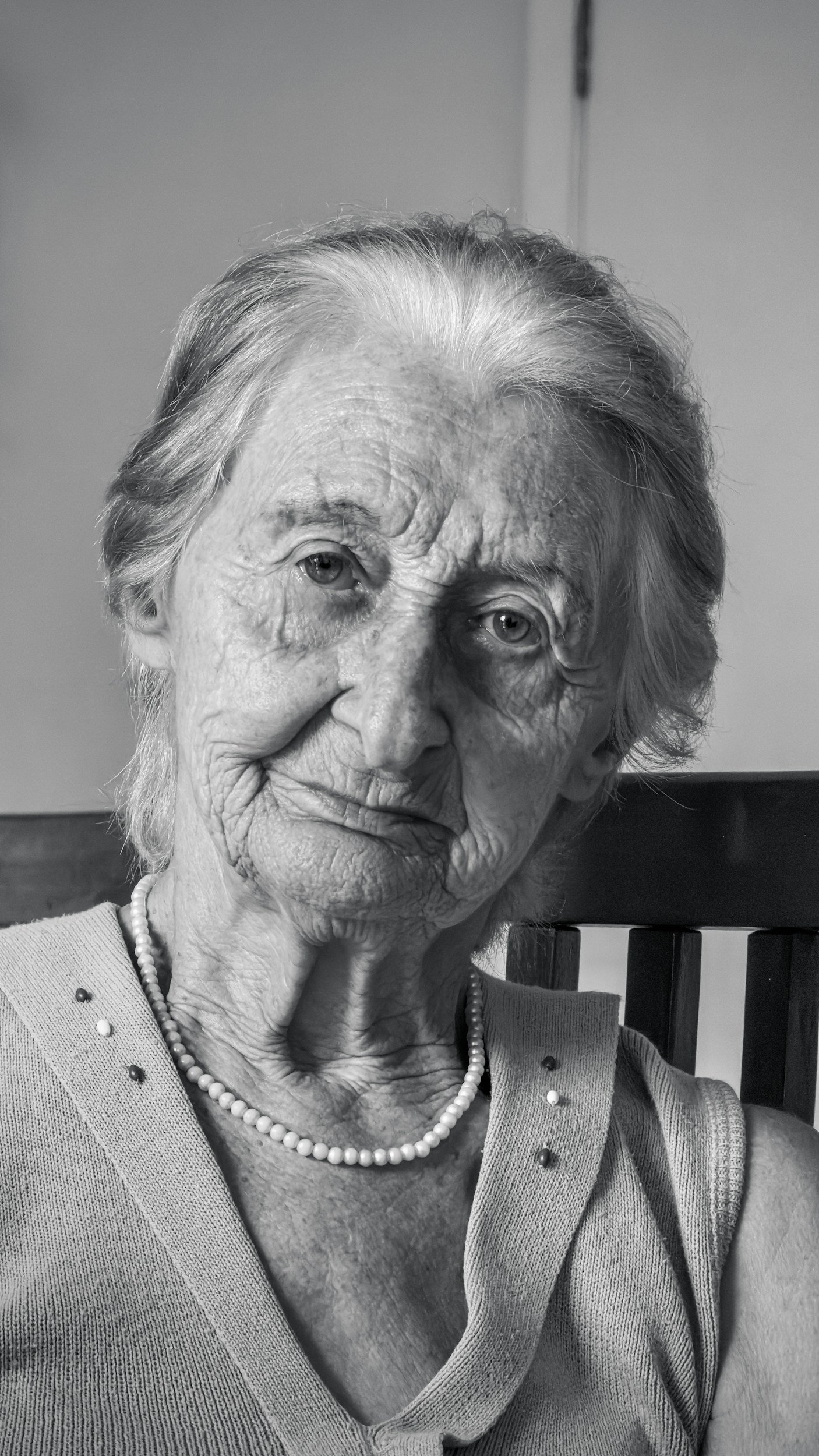 elderly lady sitting on a chair