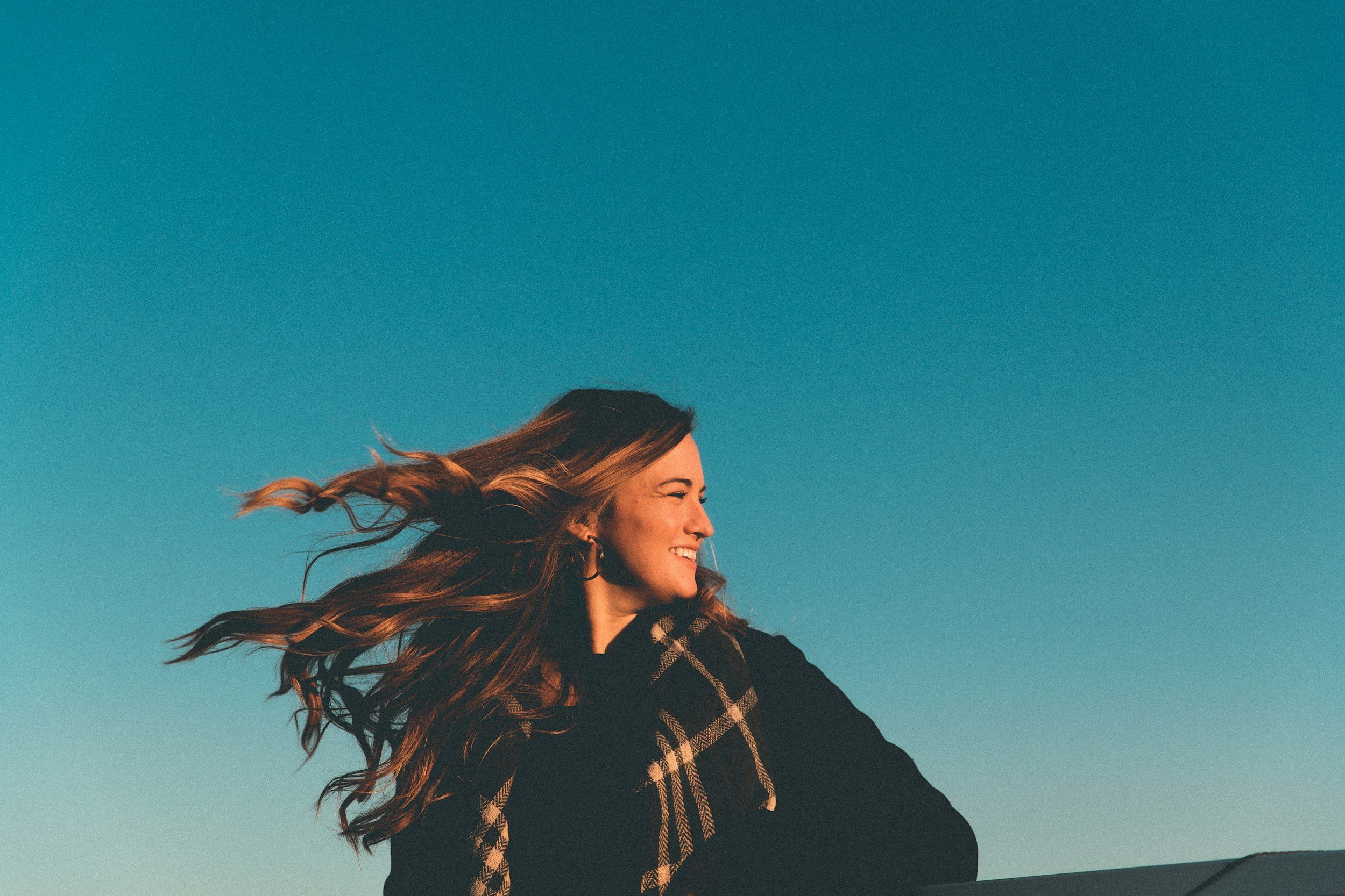 smiling woman with a scarf with blue sky background