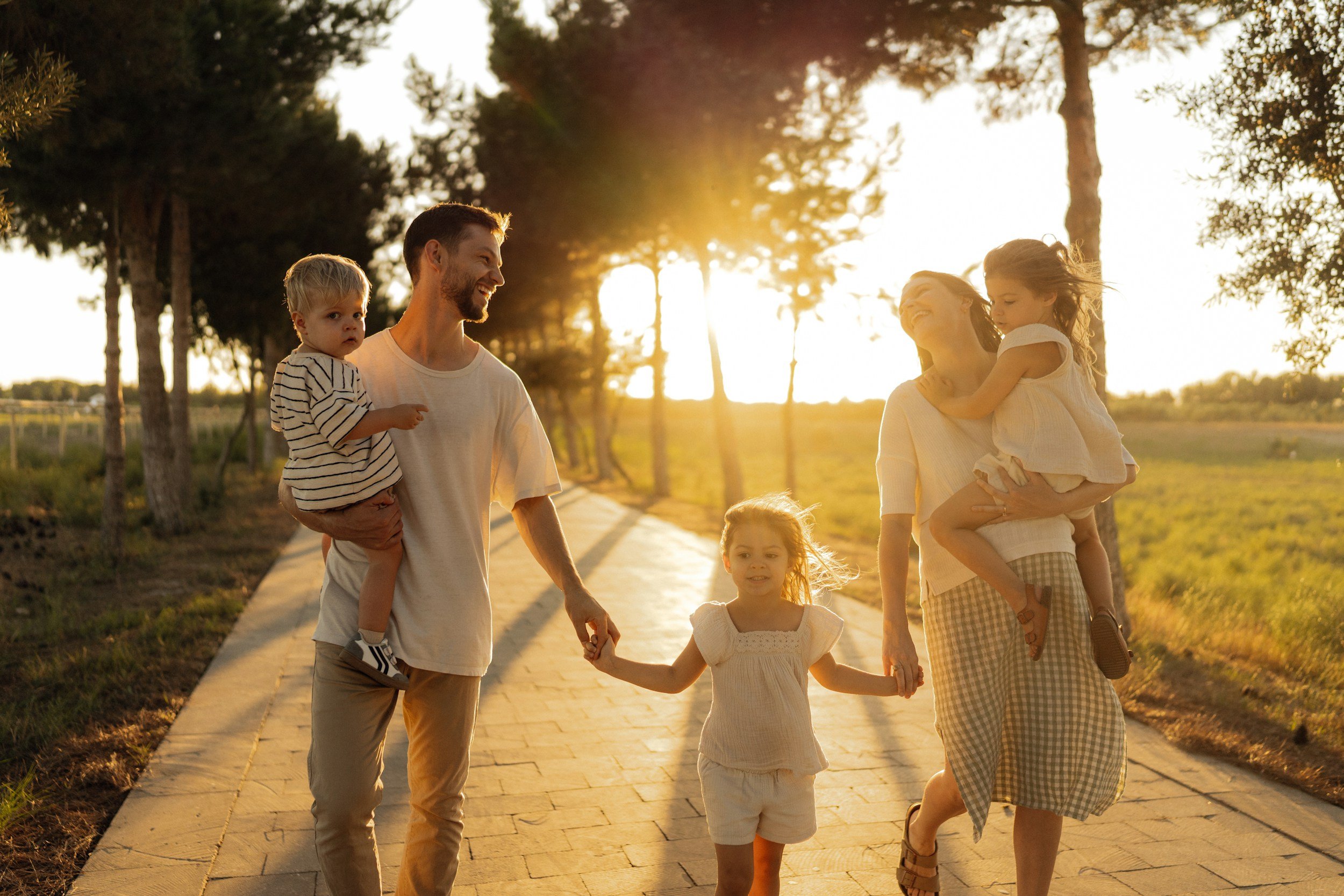 young family walking outside together holding hands