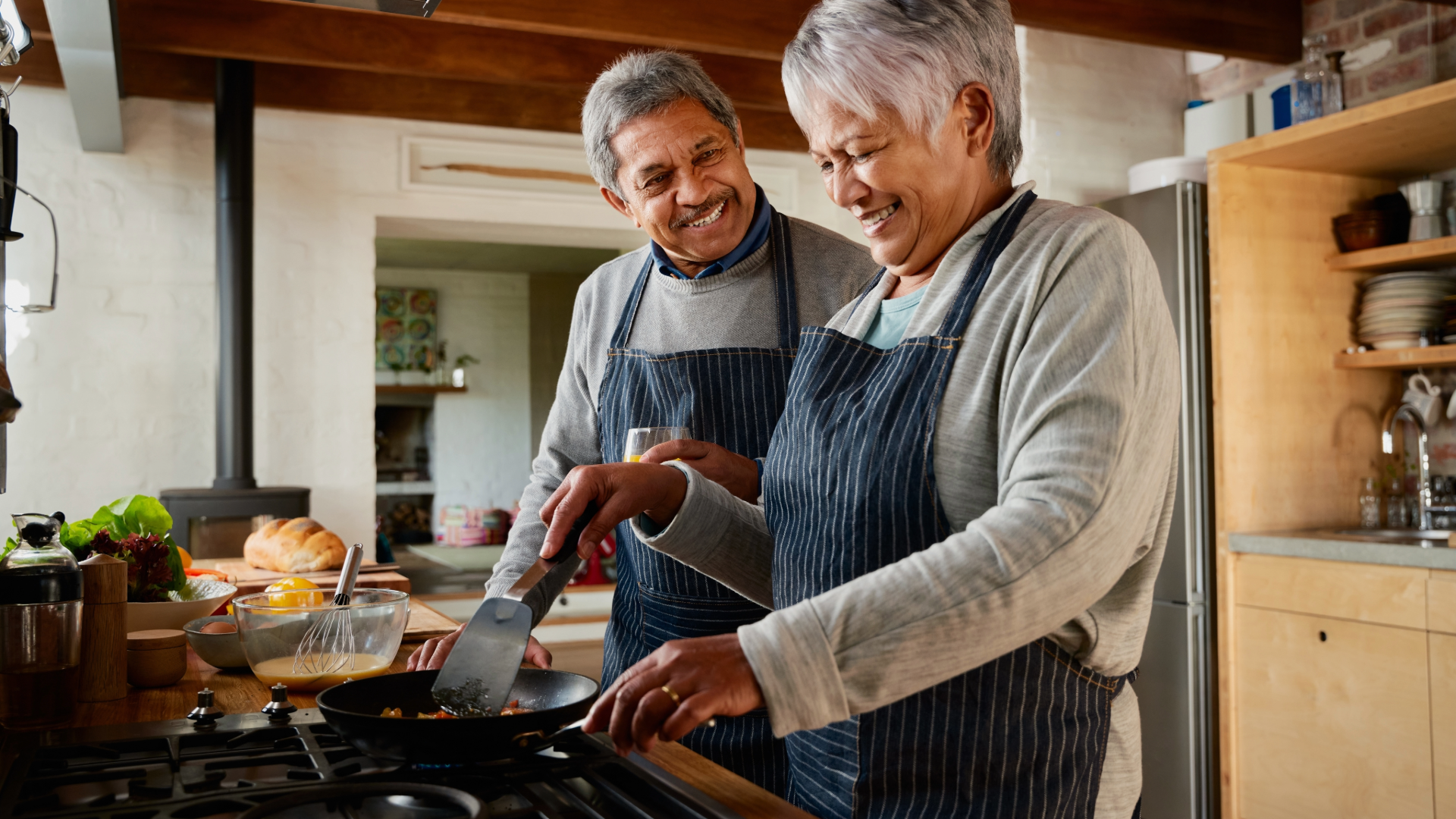 retired couple cooking at home