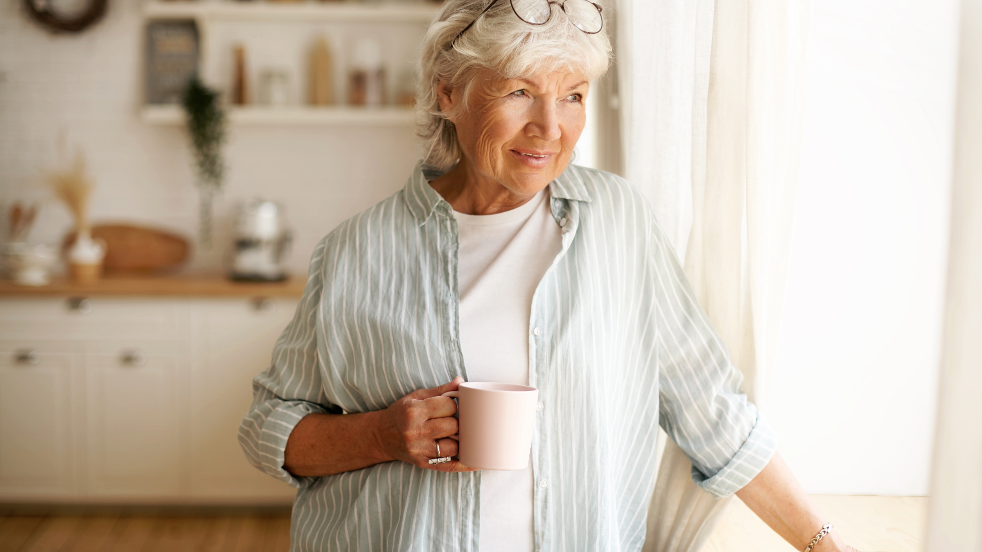 Lady having coffee in her kitchen