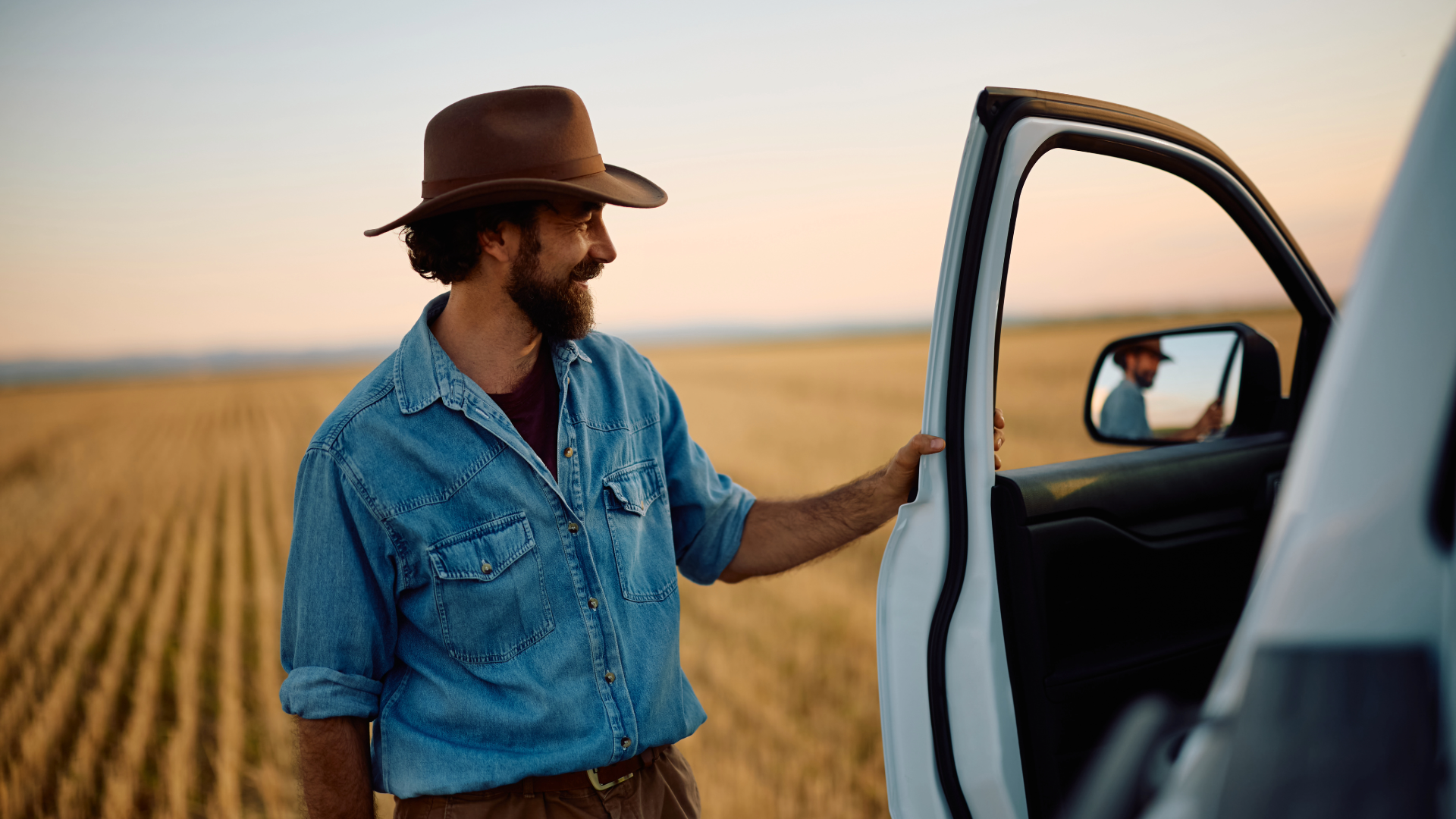 pickup truck corn field cowboy hat.png