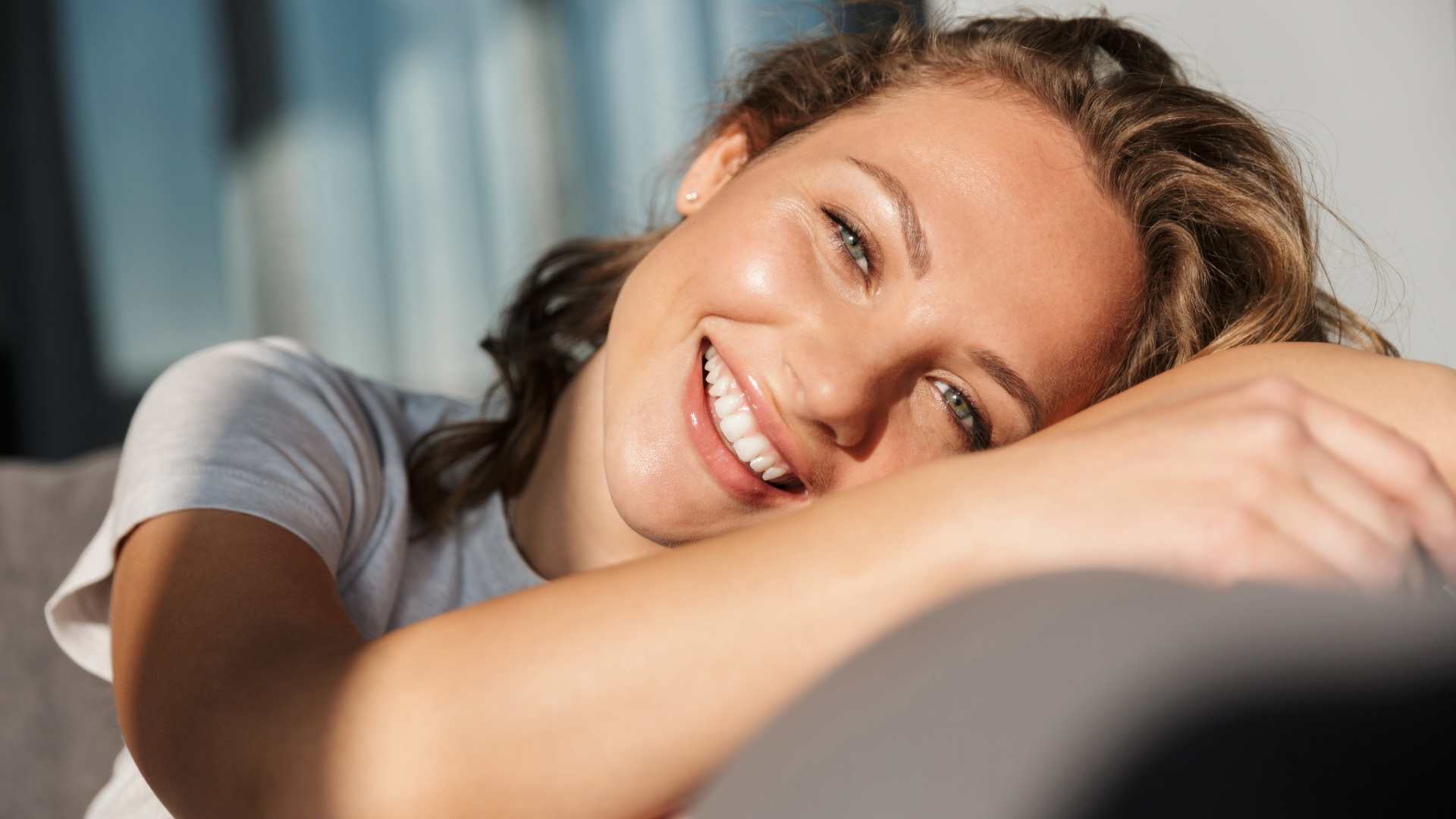 young lady smiling sitting on sofa