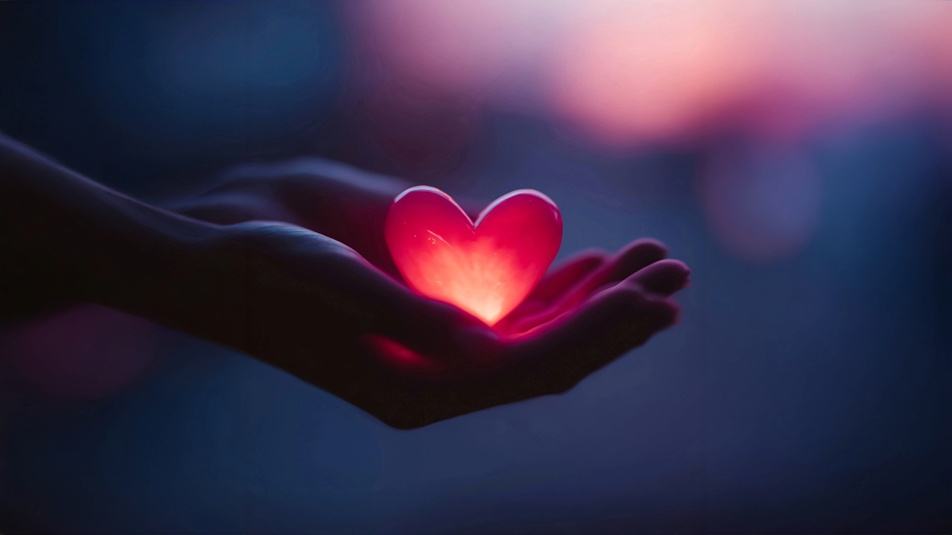 open hands with illuminated red heart in palms of a woman