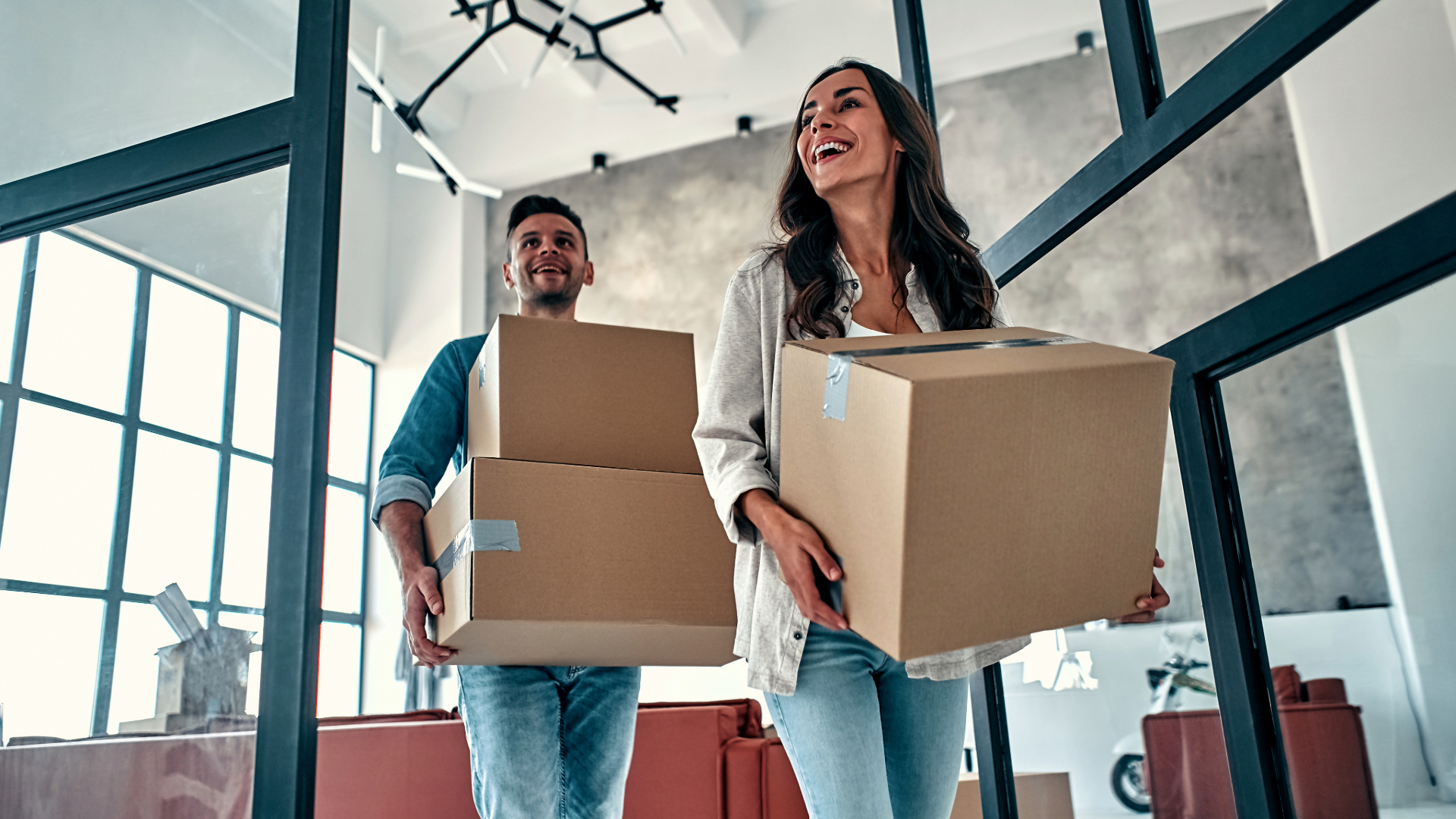 young couple moving into their new apartment with moving boxes