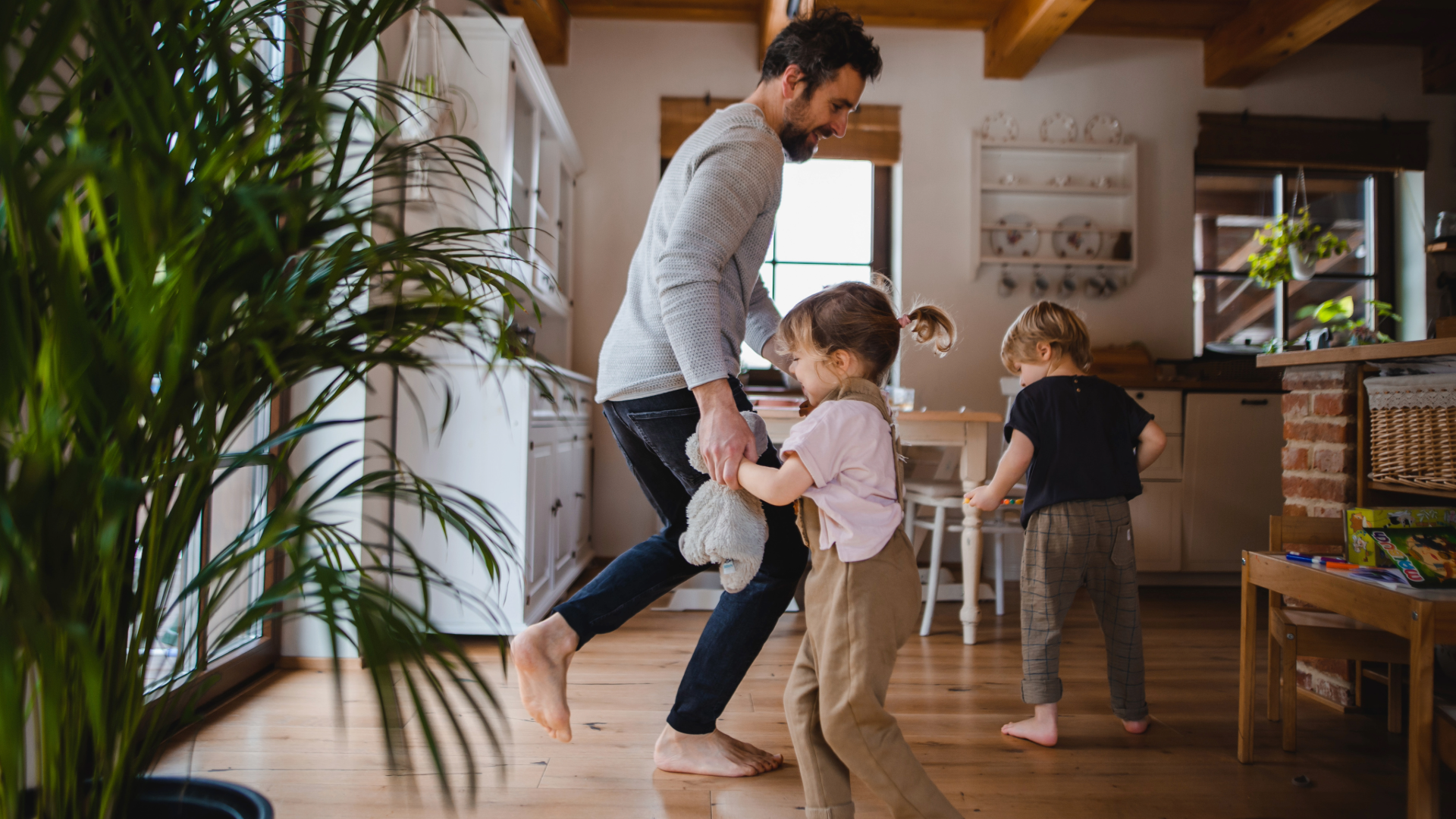 father and kids dancing at home