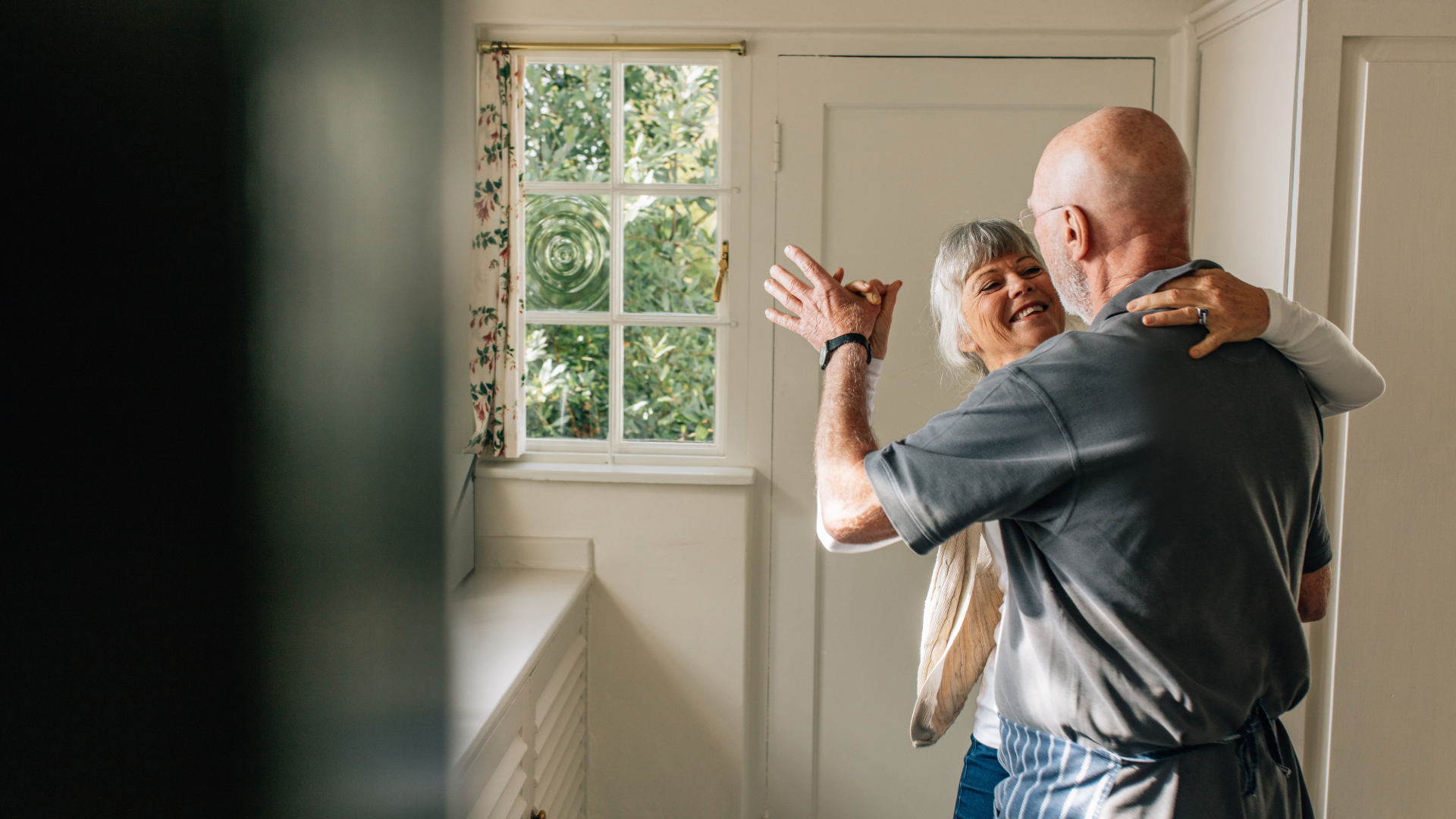 retired couple dancing at home
