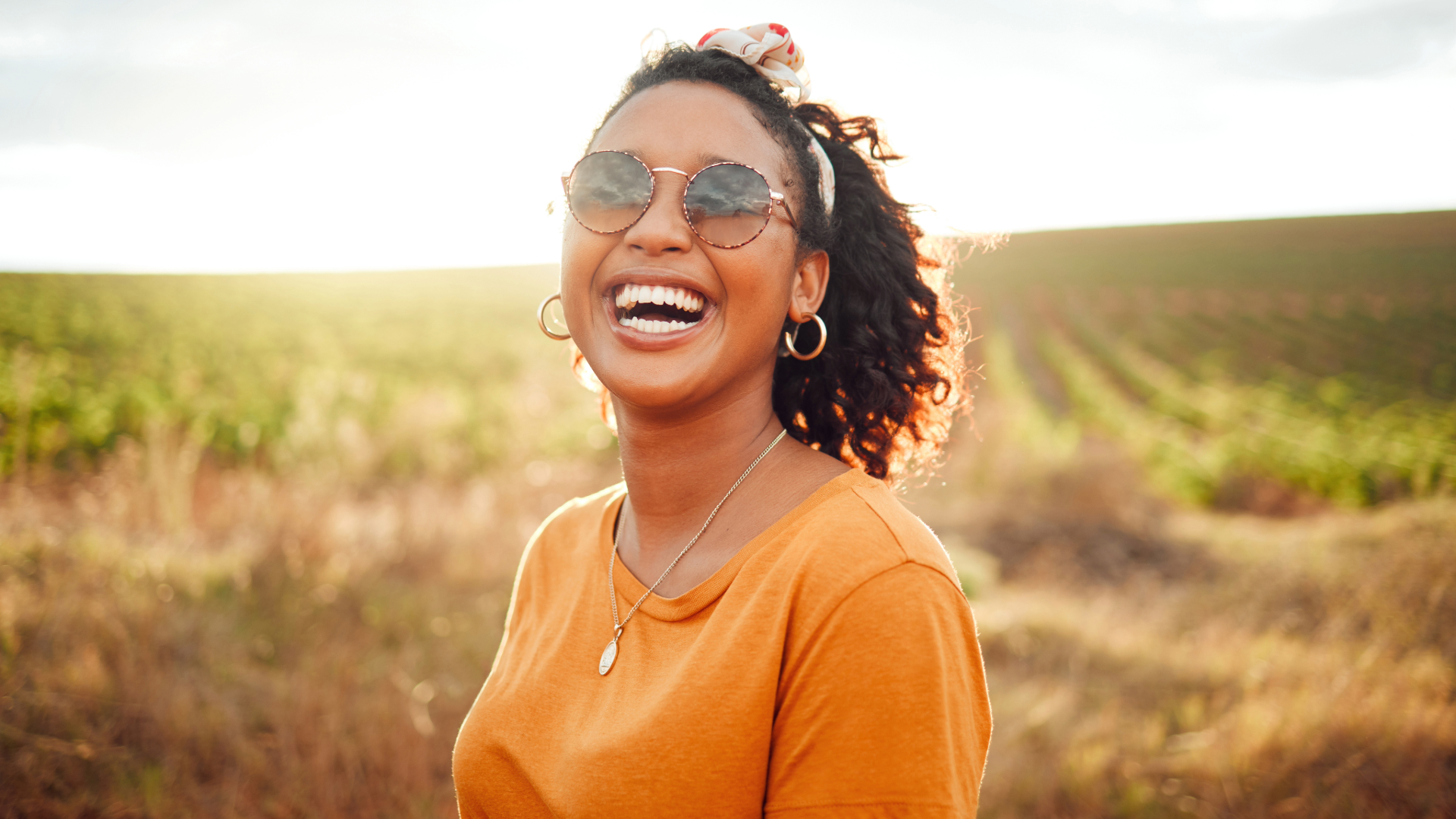 lady outside in field smiling