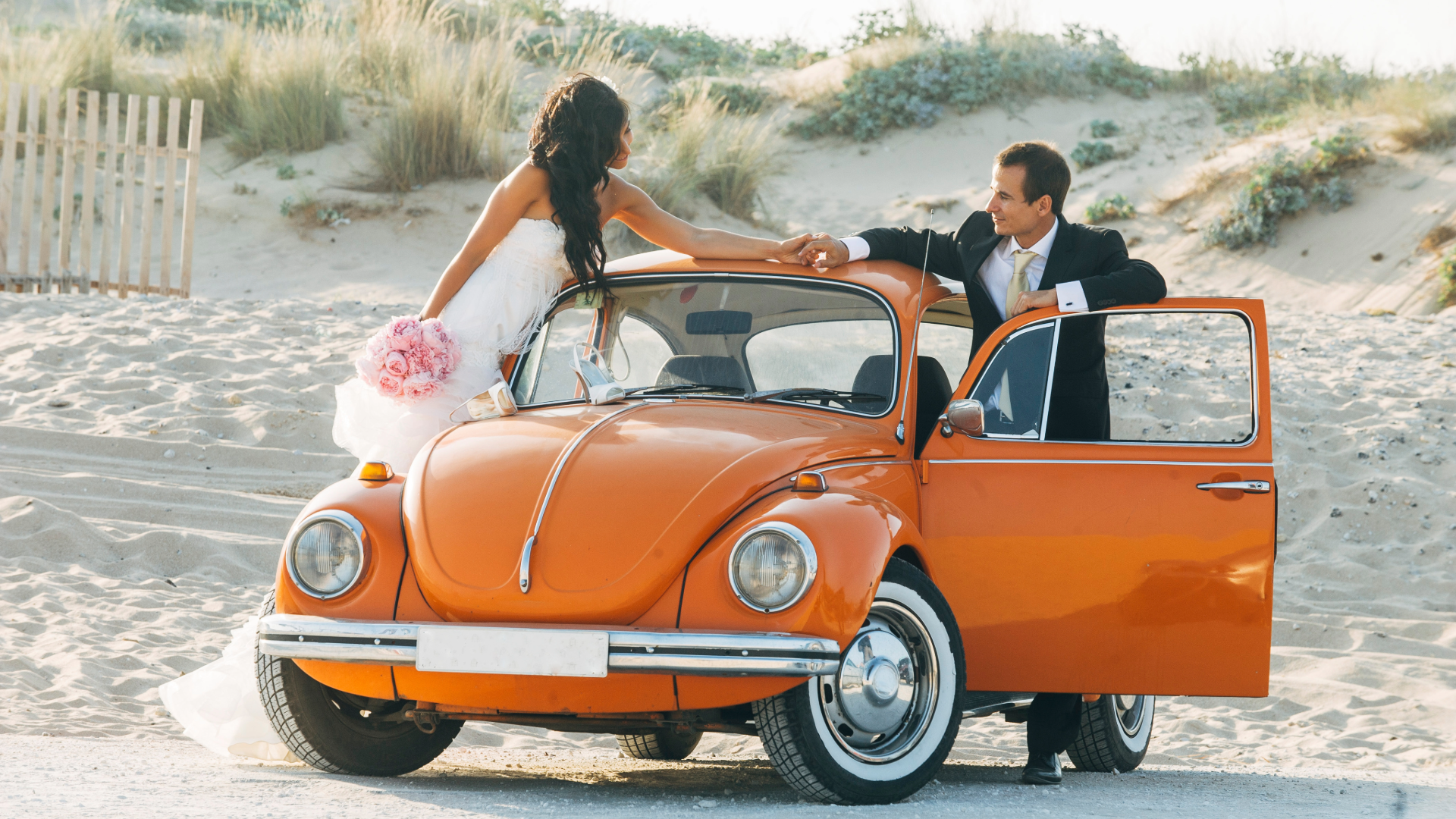 orange vw beetle wedding on the beach