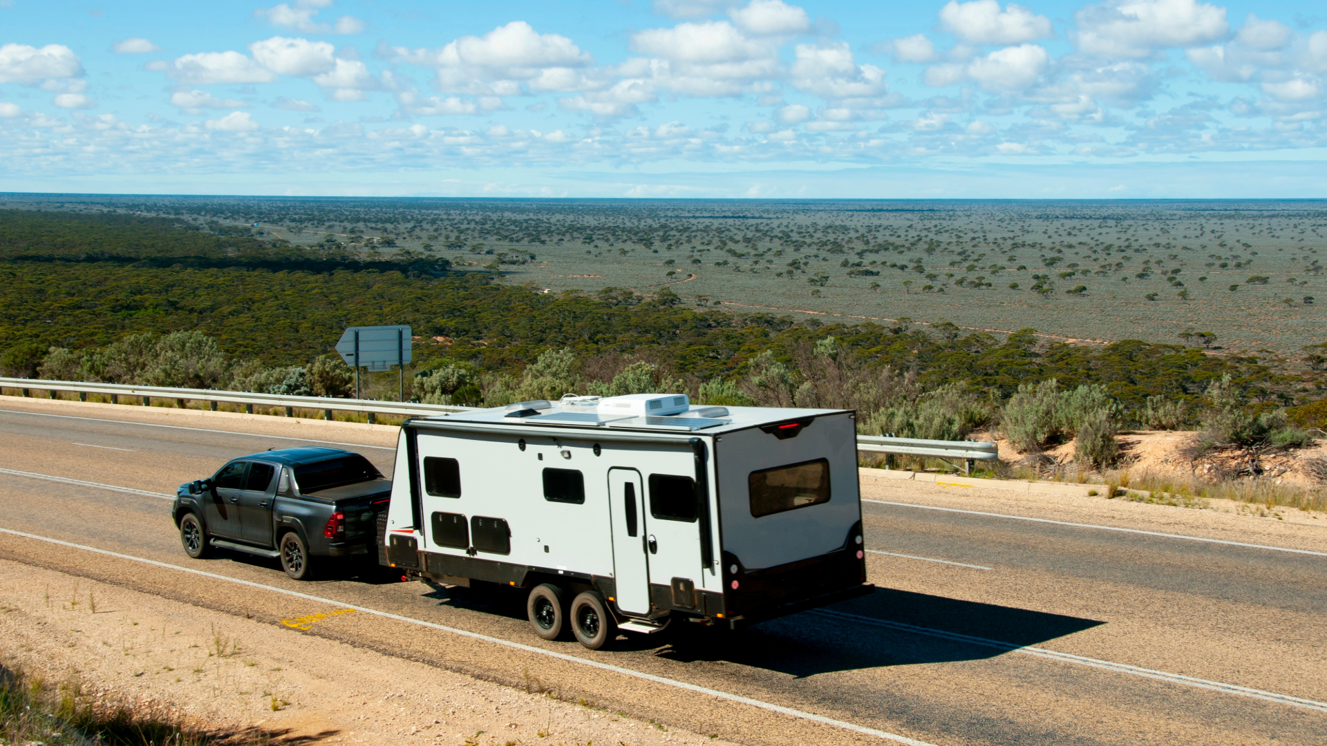 black pickup truck hauling travel trailer