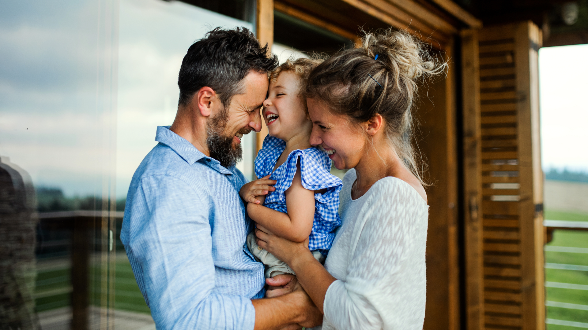 young family laughing and smiling at home