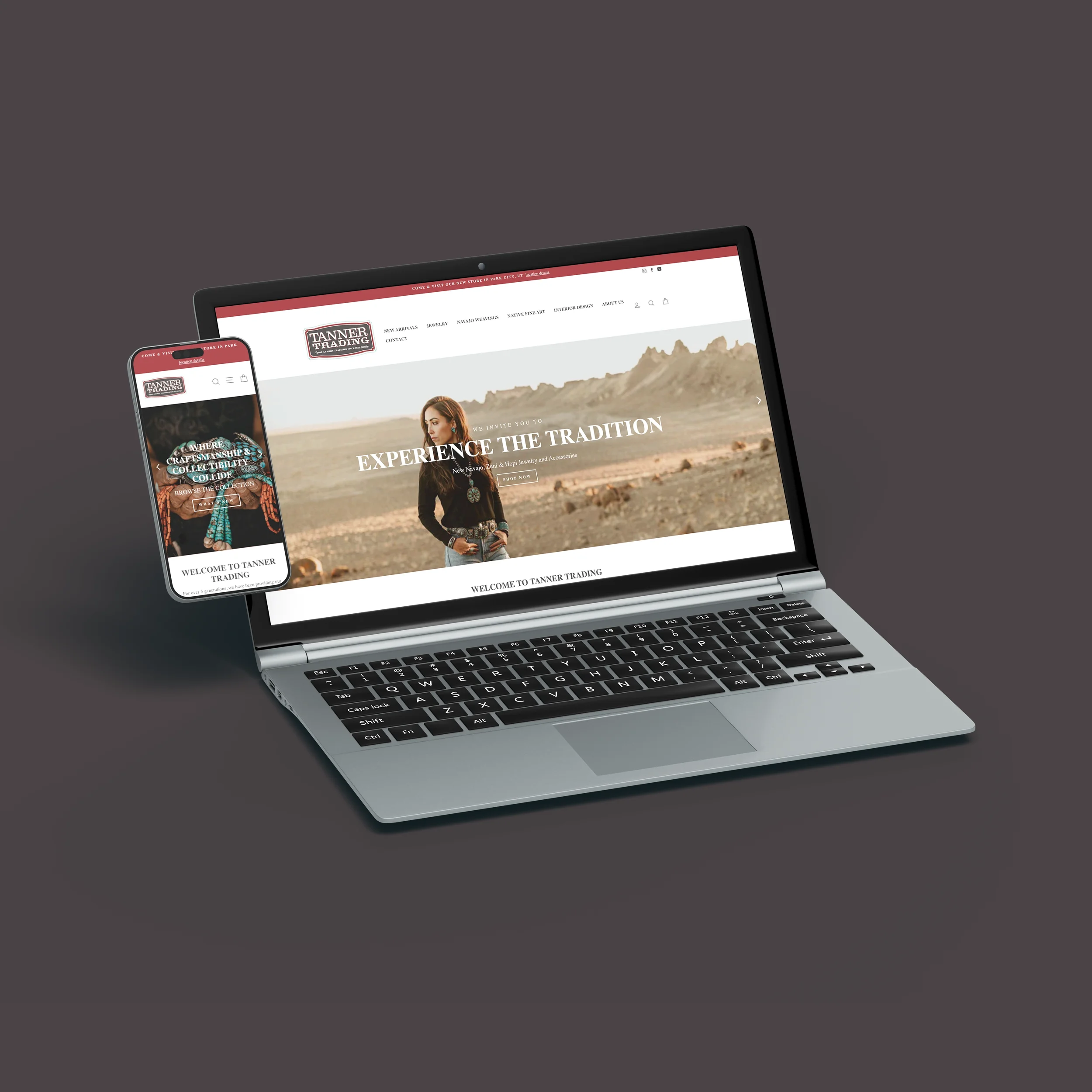 Open laptop and smartphone displaying the Tanner Trading website, featuring a woman in a desert landscape.