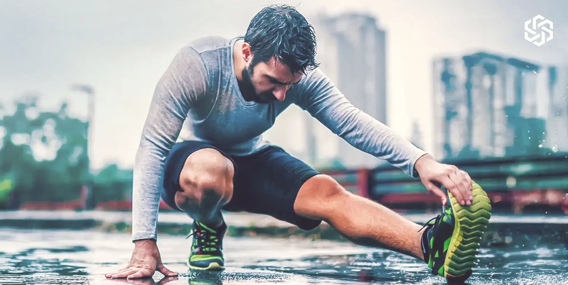 A woman with fair skin and brown hair tied back, holding a glass of water in her right hand and a capsule pill in her left hand, with a light blue background featuring white hexagonal and geometric patterns.