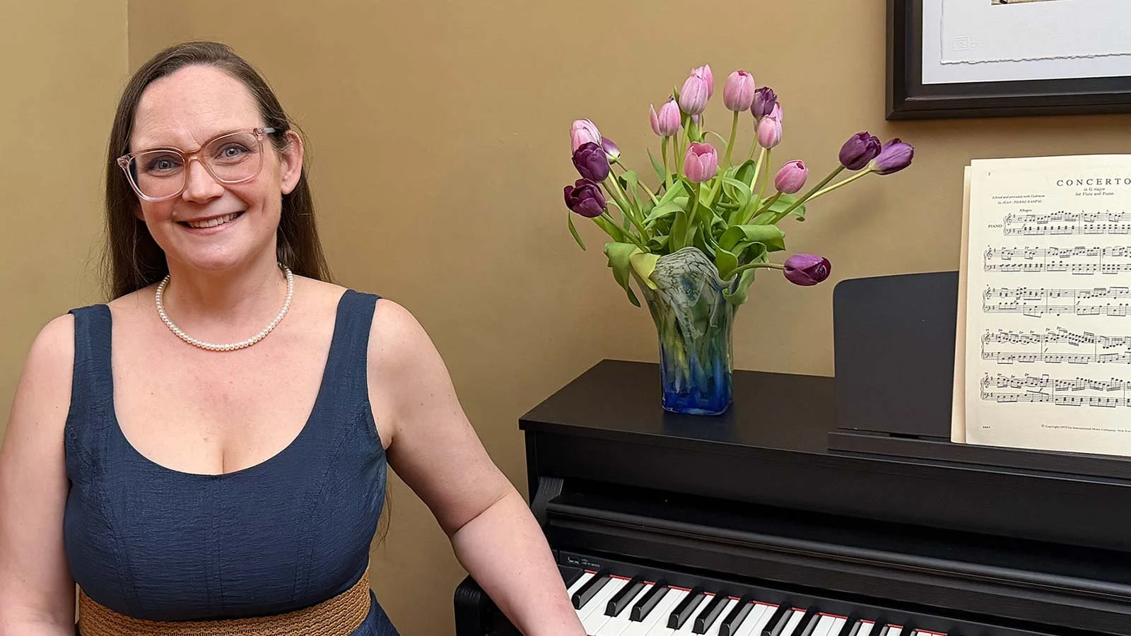 Photo of Sarah Gaw next to a piano