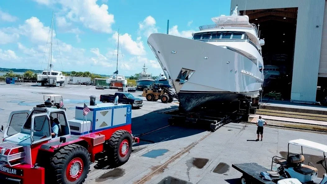 Vessel transitioning from work shed to working yard via rail system for antifouling application — KEY Marine Advisors project management oversight, East Coast United States