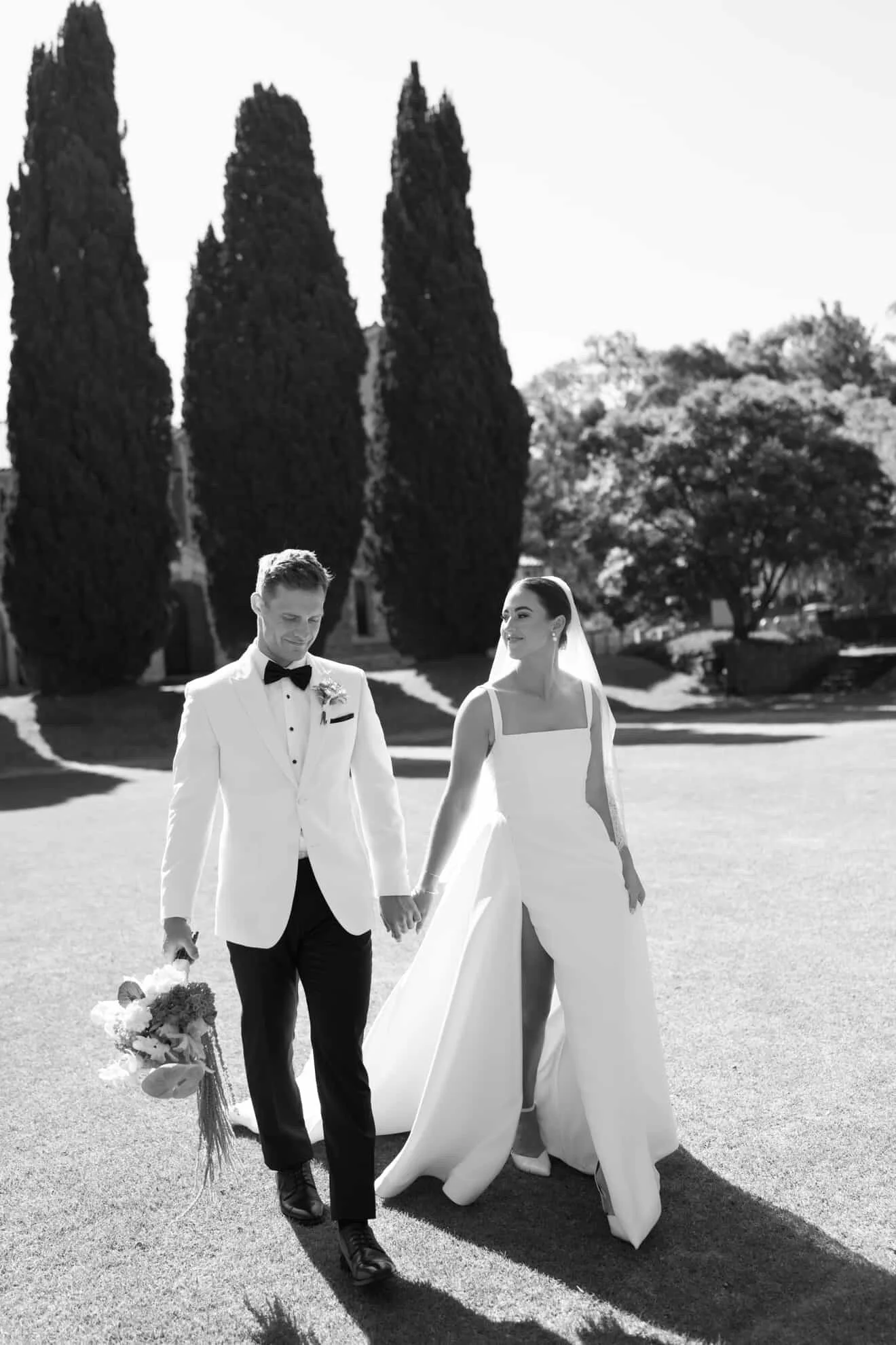 couple walking with bouquet - B&W 956C4DF5-4A80-4C72-B329-E69F219F7609.JPG