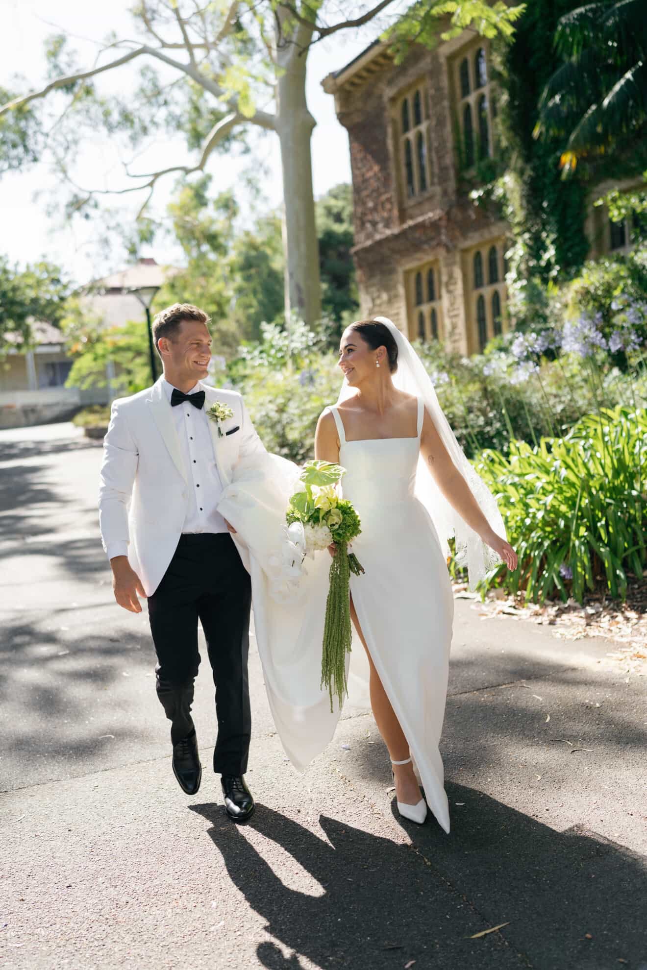 couple walking with bouquet B&W D3386253-B161-4E3B-8918-ACDE36AEA978.JPG