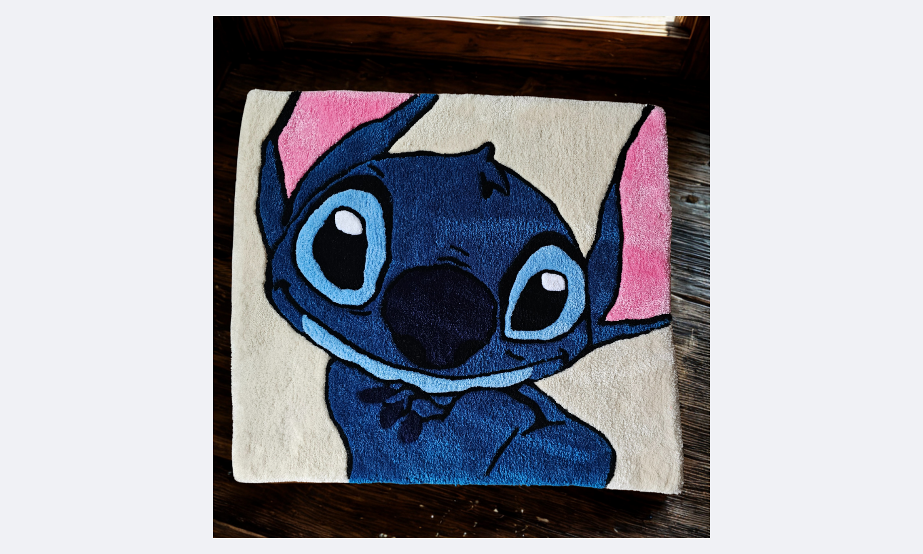 Colorful rug featuring a cartoon depiction of Stitch from Disney's Lilo & Stitch, with large eyes, big nose, and pink ears, on a beige background.