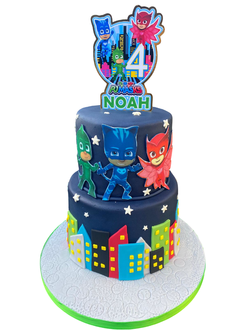 A three-tier cake themed from PJ Masks featuring characters Catboy, Gekko, and Owlette, with cityscape decorations around the bottom tier and stars on the middle tier, topped with a cake topper celebrating Noah's 4th birthday.