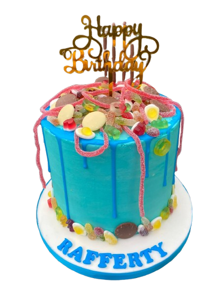 Colorful birthday cake with blue frosting, topped with candy decorations and pink sprinkles, and a gold "Happy Birthday" topper. The cake has "RAFFERTY" written in blue on the white base.
