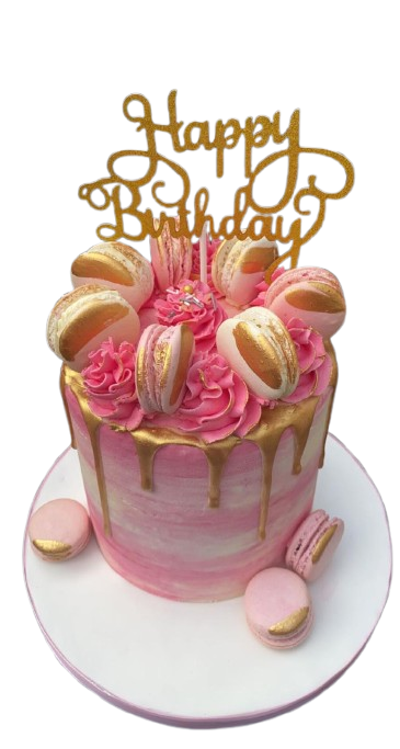Pink birthday cake decorated with macaroons, pink frosting, and gold drip icing. Gold and pink 'Happy Birthday' topper on the cake.