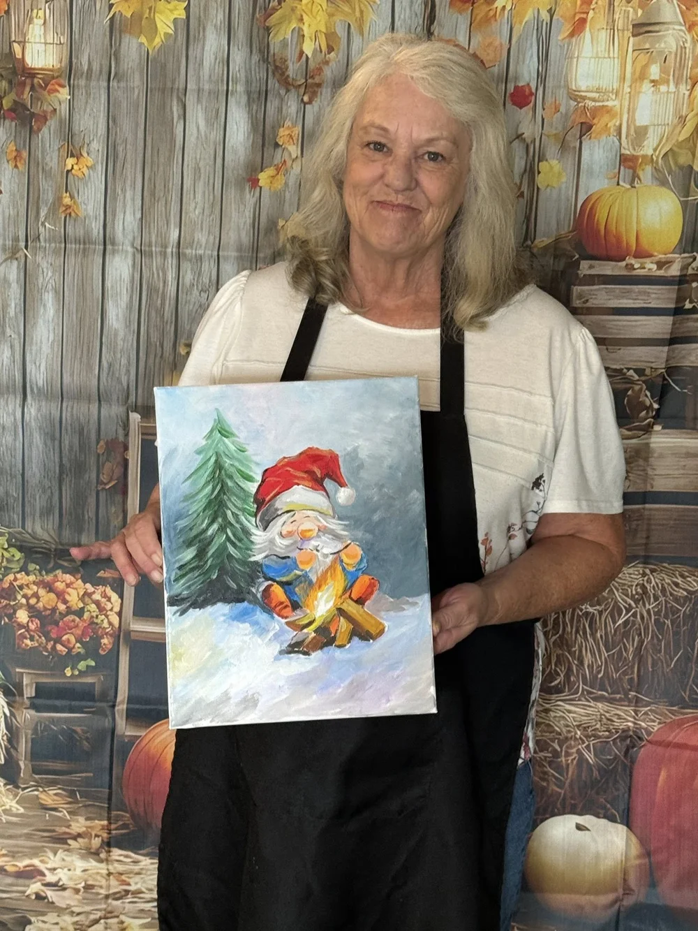 Young Knoxville Art Studio student holding a finished painting