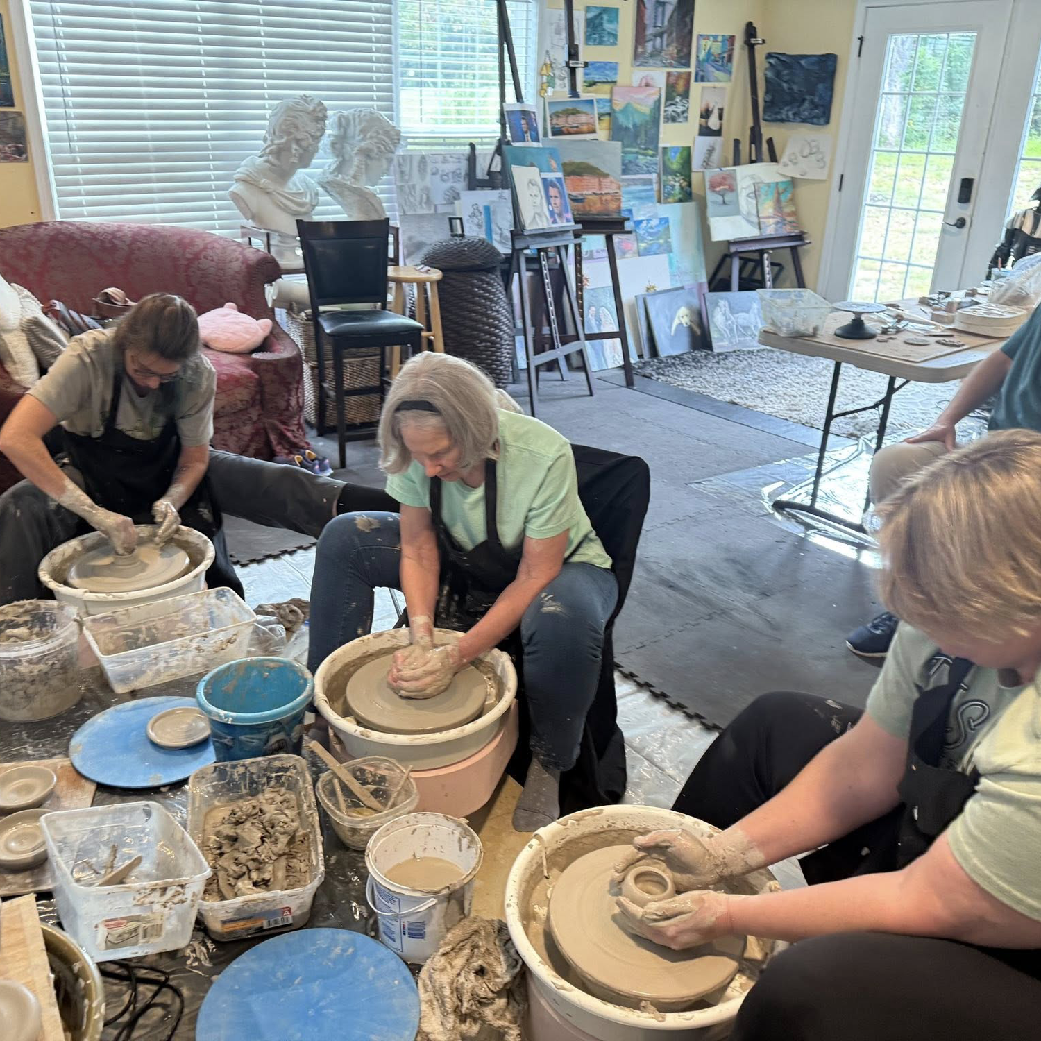 Adults learning pottery and working with clay at Knoxville Art Studio