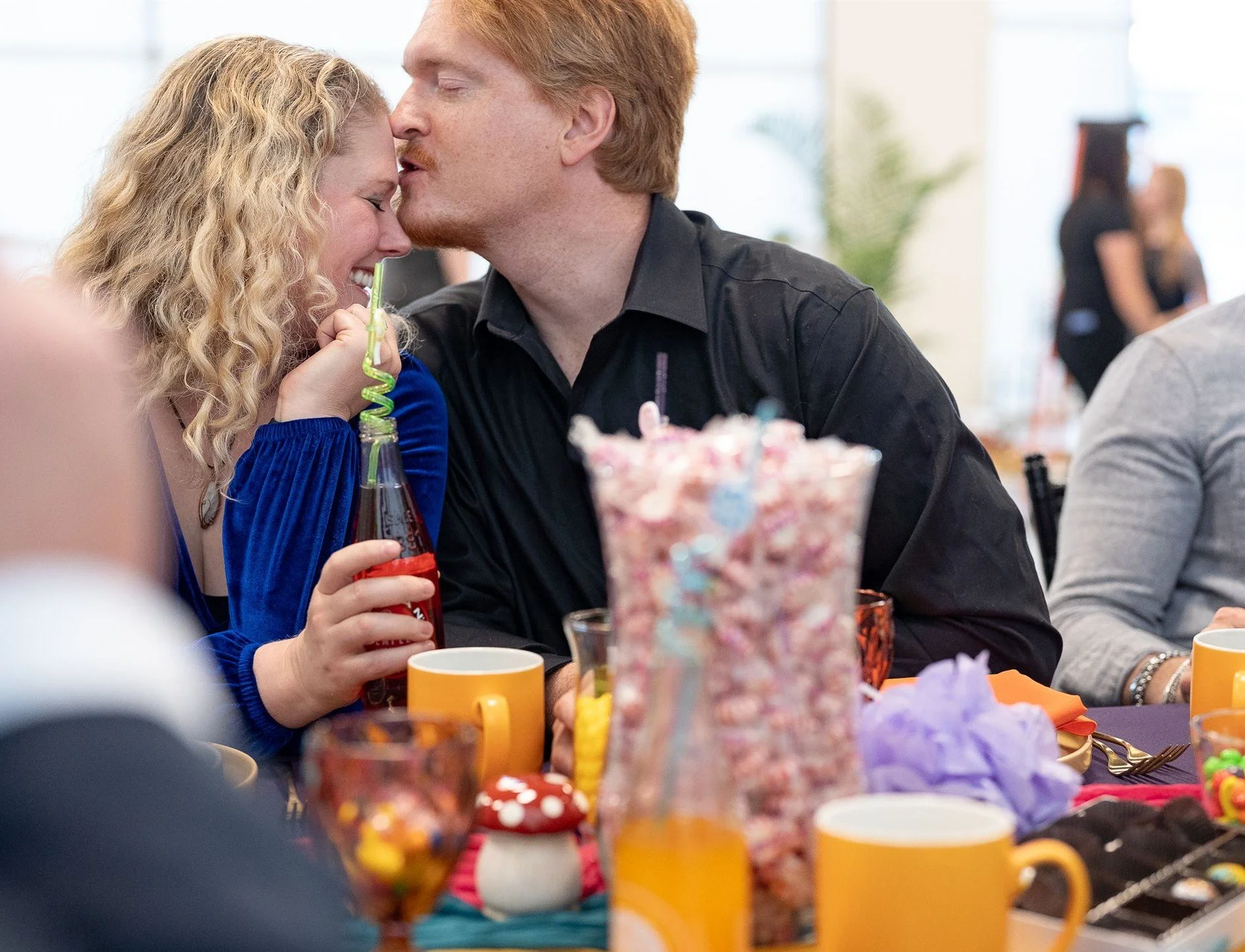 Couple smooch at event in Enchanted Events Center