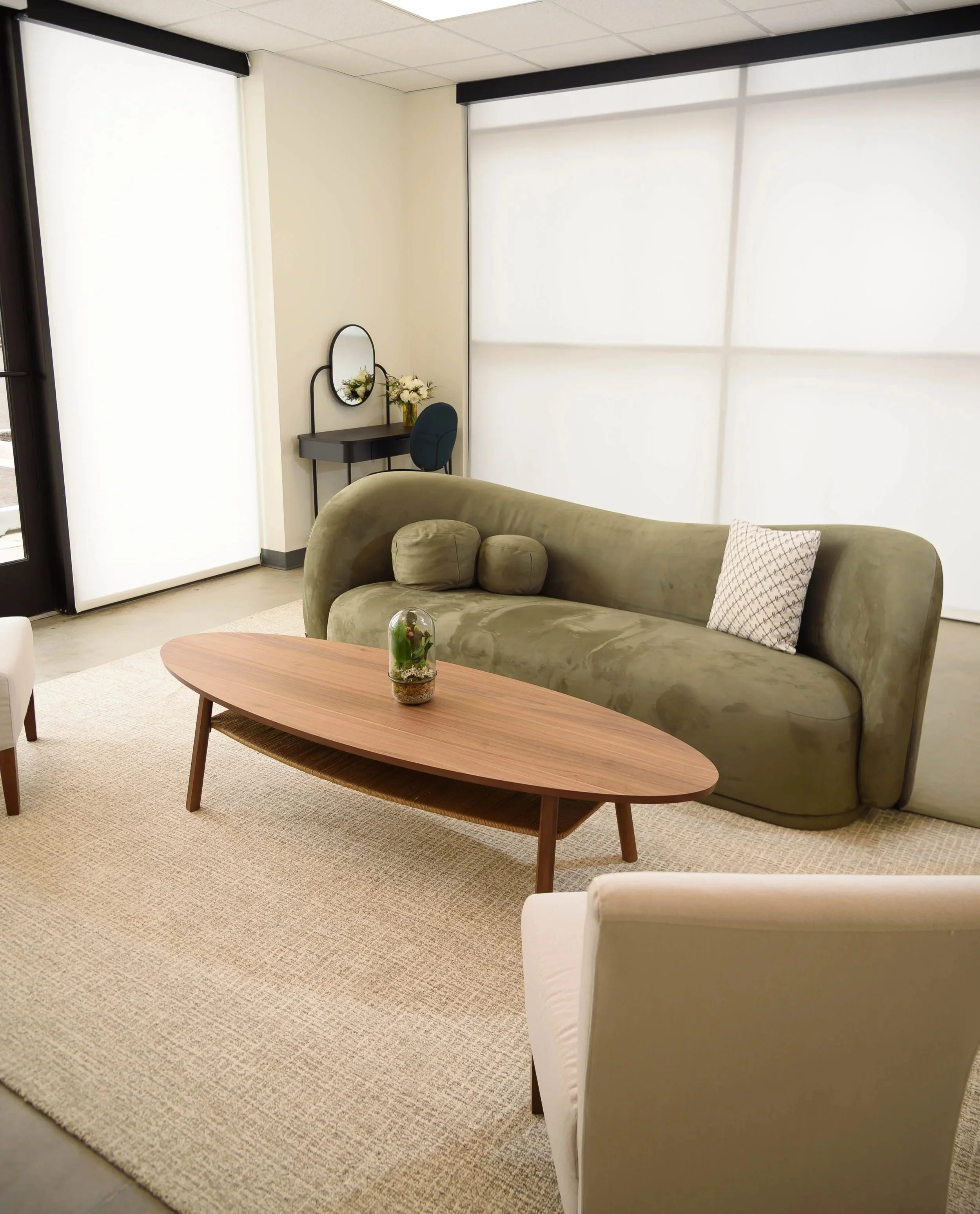 Our elegant getting ready/prep room with a sleek modern couch, chairs, mirrors, and vanities