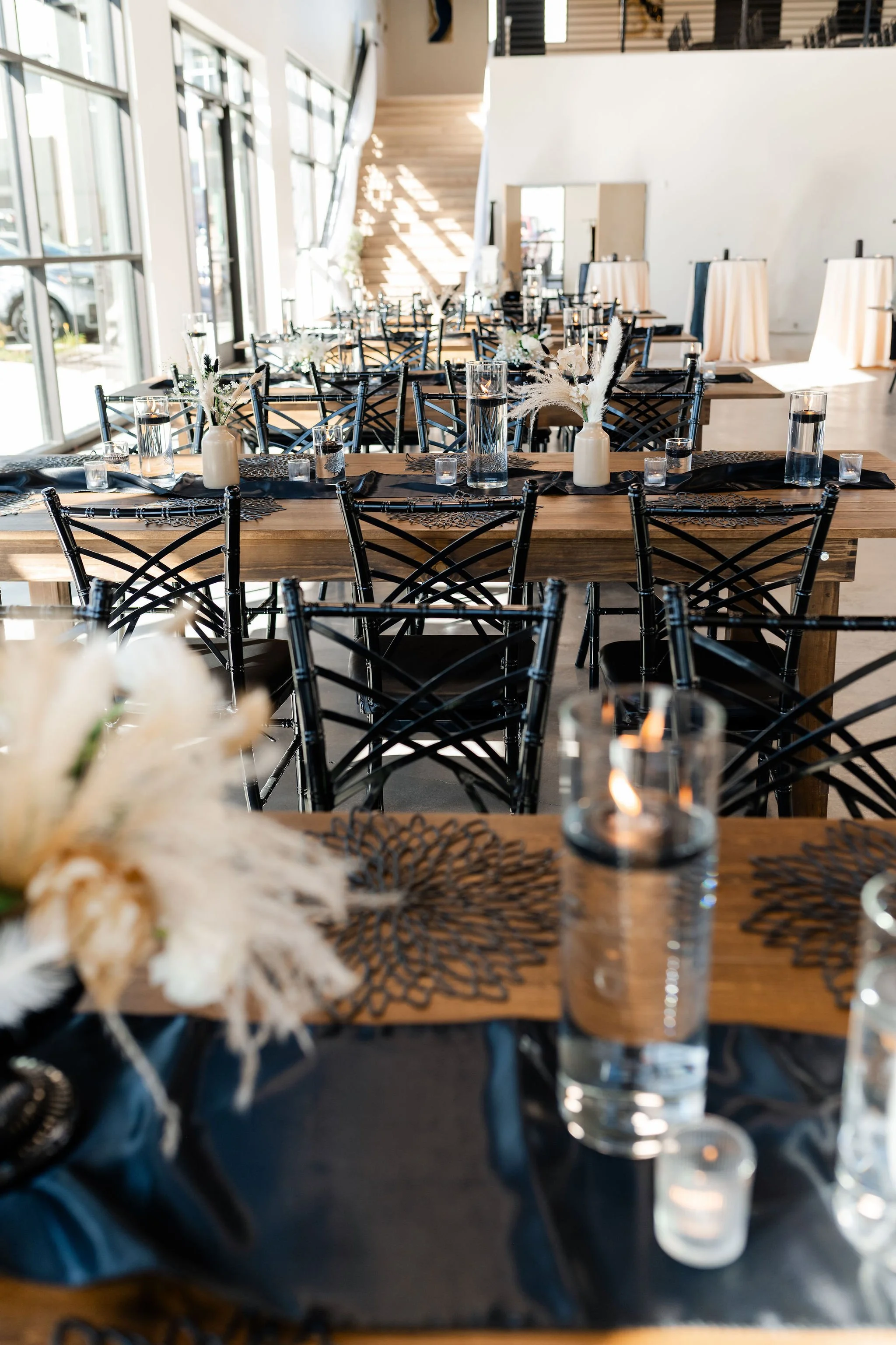 A view of a row of our beautiful hall style tables and staircase in our Enchanted Hall