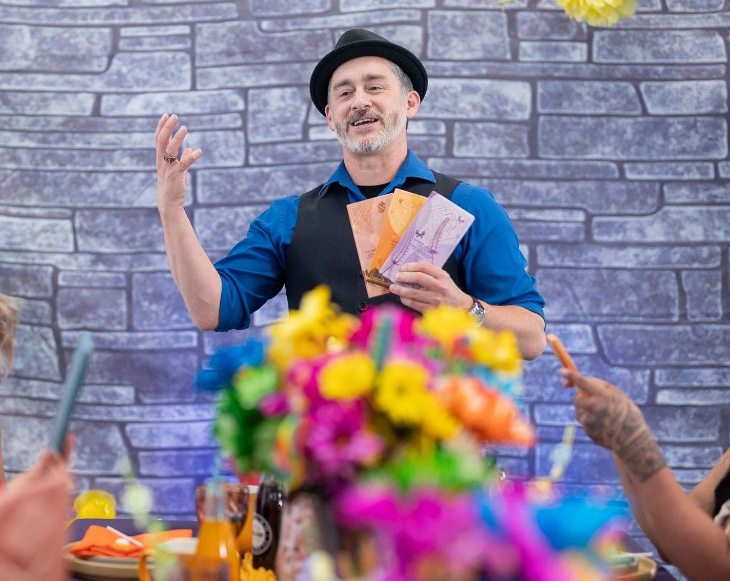 Willy Wonka party host presents tickets at party
