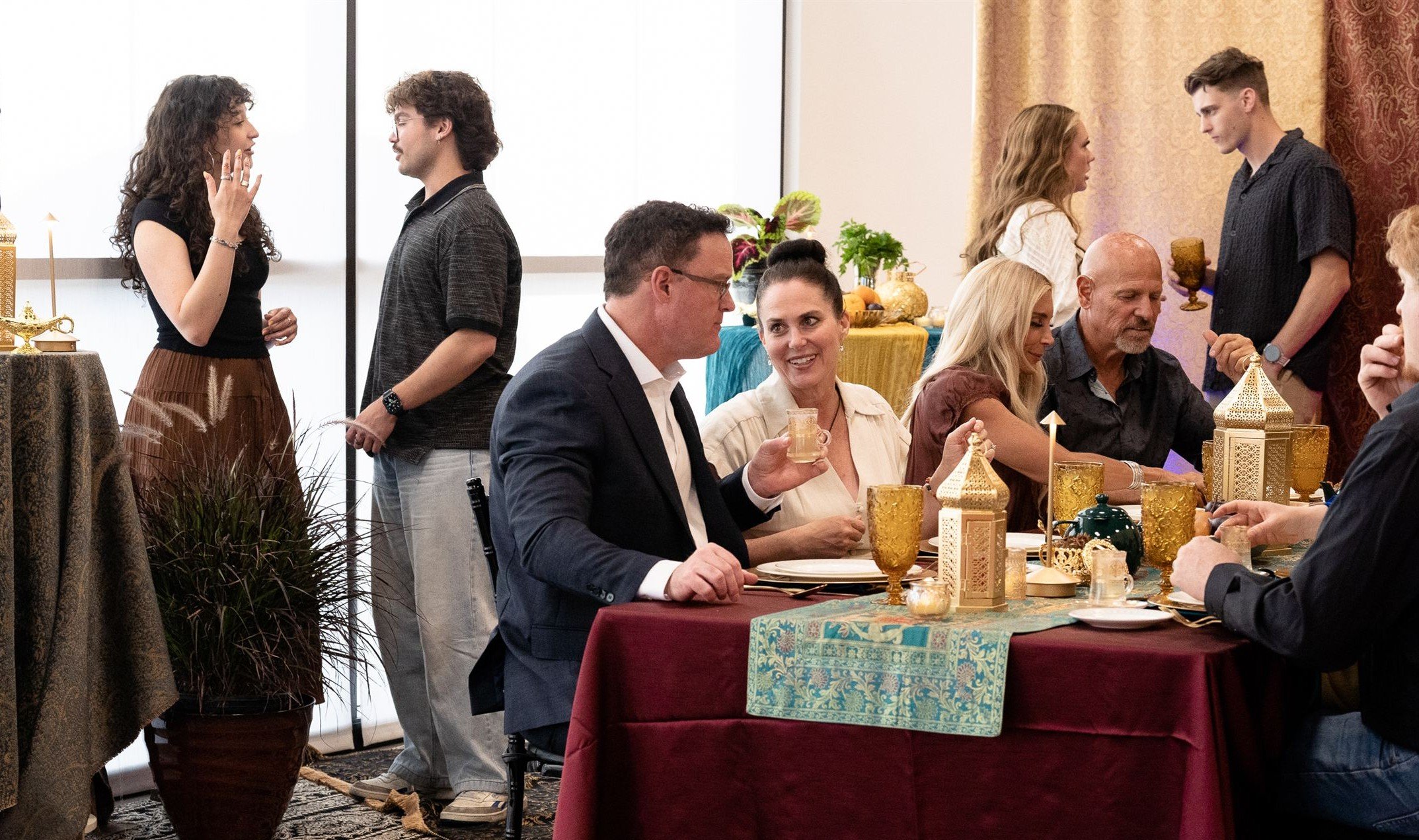 Guests mingling in Eastern Indian style party at Herriman event venue