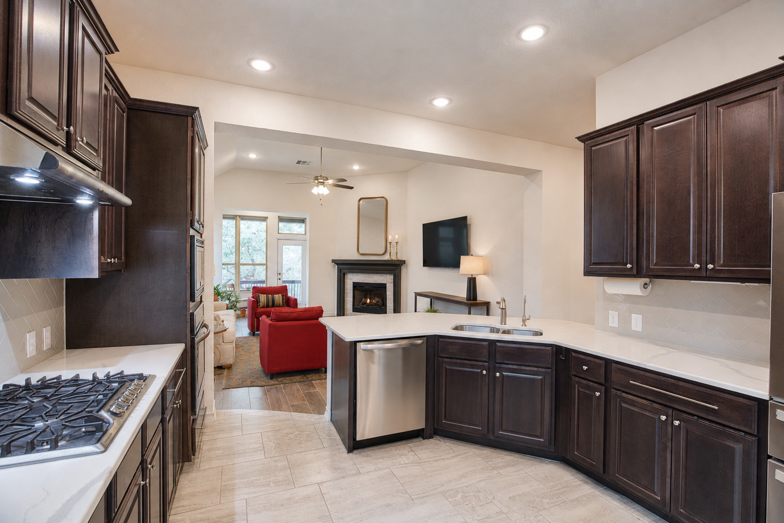 View of modern kitchen with dark wood cabinets of 3051 Blenheim Park, Bulverde, Texas.