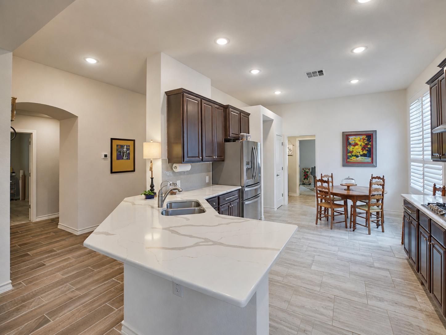 A modern kitchen with a white marble island of 3051 Blenheim Park, Bulverde, Texas.