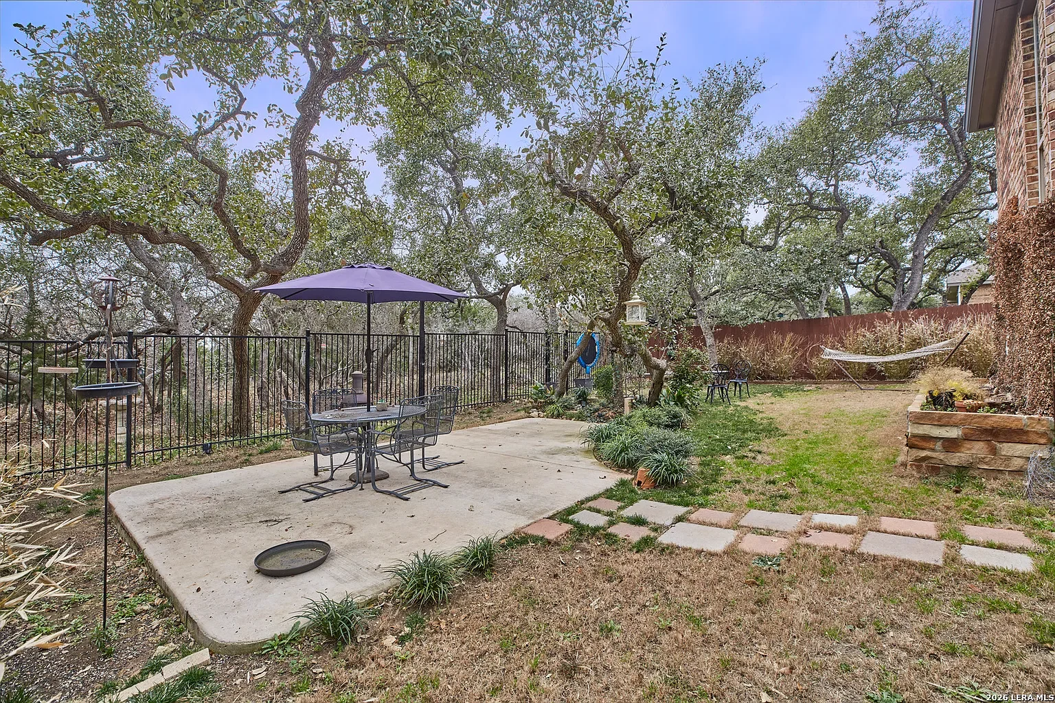 A backyard with a concrete patio at 3051 Blenheim Park, Bulverde, Texas.