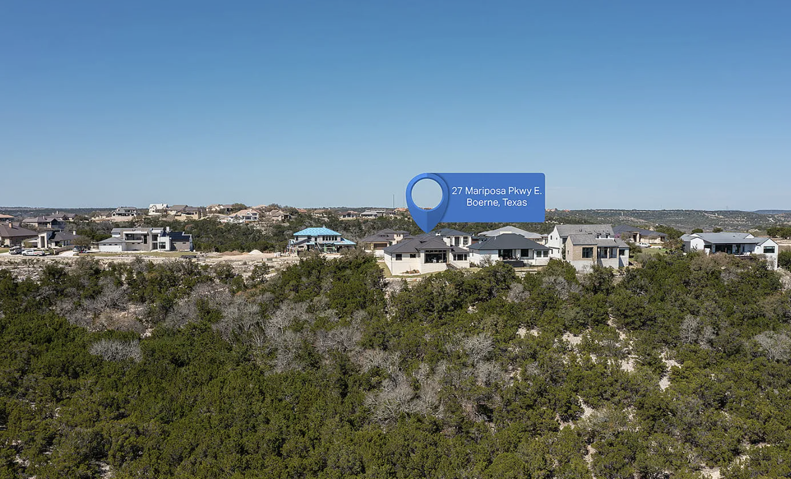 An aerial view of residential houses in a suburban neighborhood of 27 Mariposa Pkwy E., Boerne, Texas