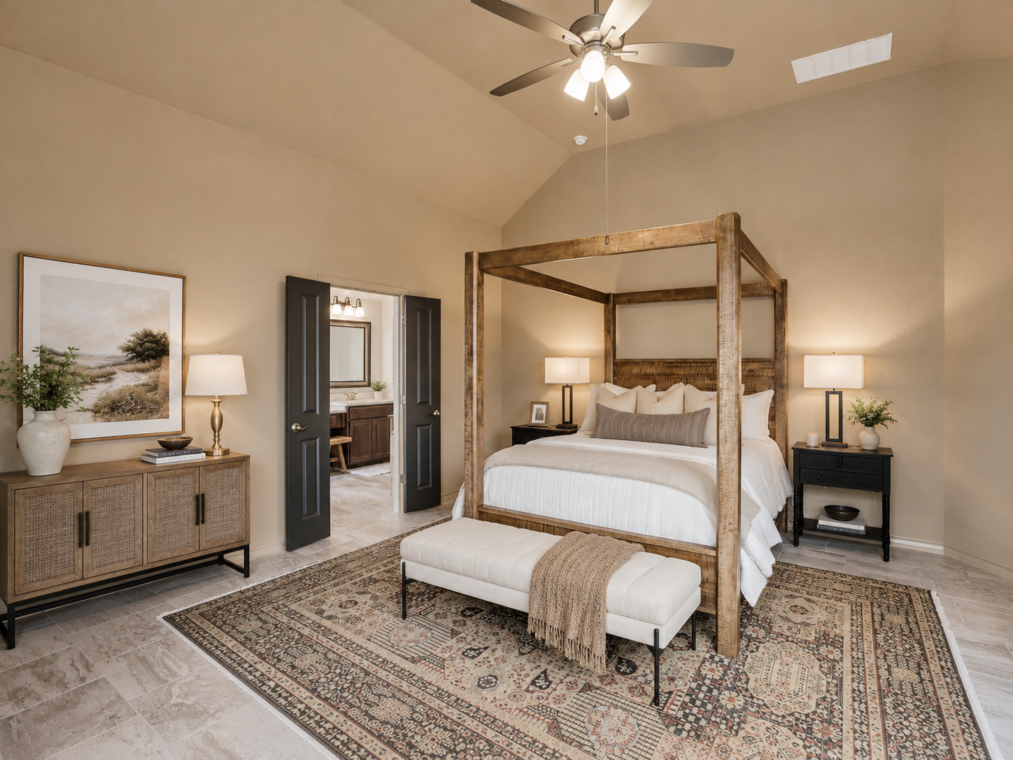 Bedroom with four-poster bed, black nightstands, lamps, beige walls, ceiling fan, bench, dresser, artwork, and doorway to bathroom of 3051 Blenheim Park, Bulverde, Texas.