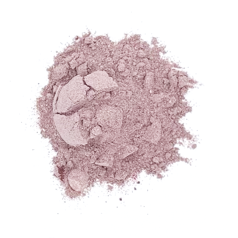 Pink powdered substance, likely makeup or cosmetic powder, scattered on a white background.
