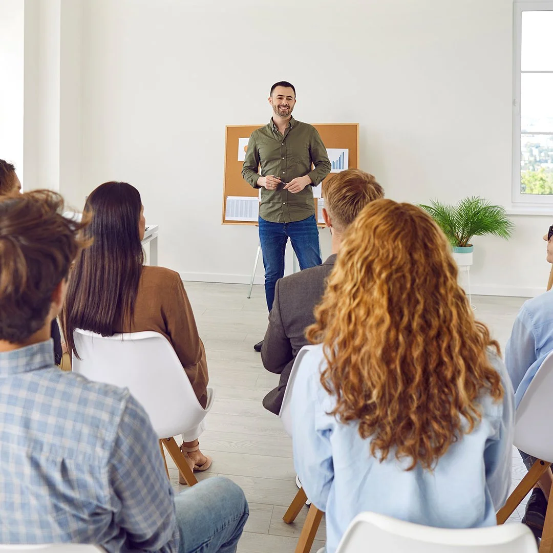A man presenting in front of a group of people