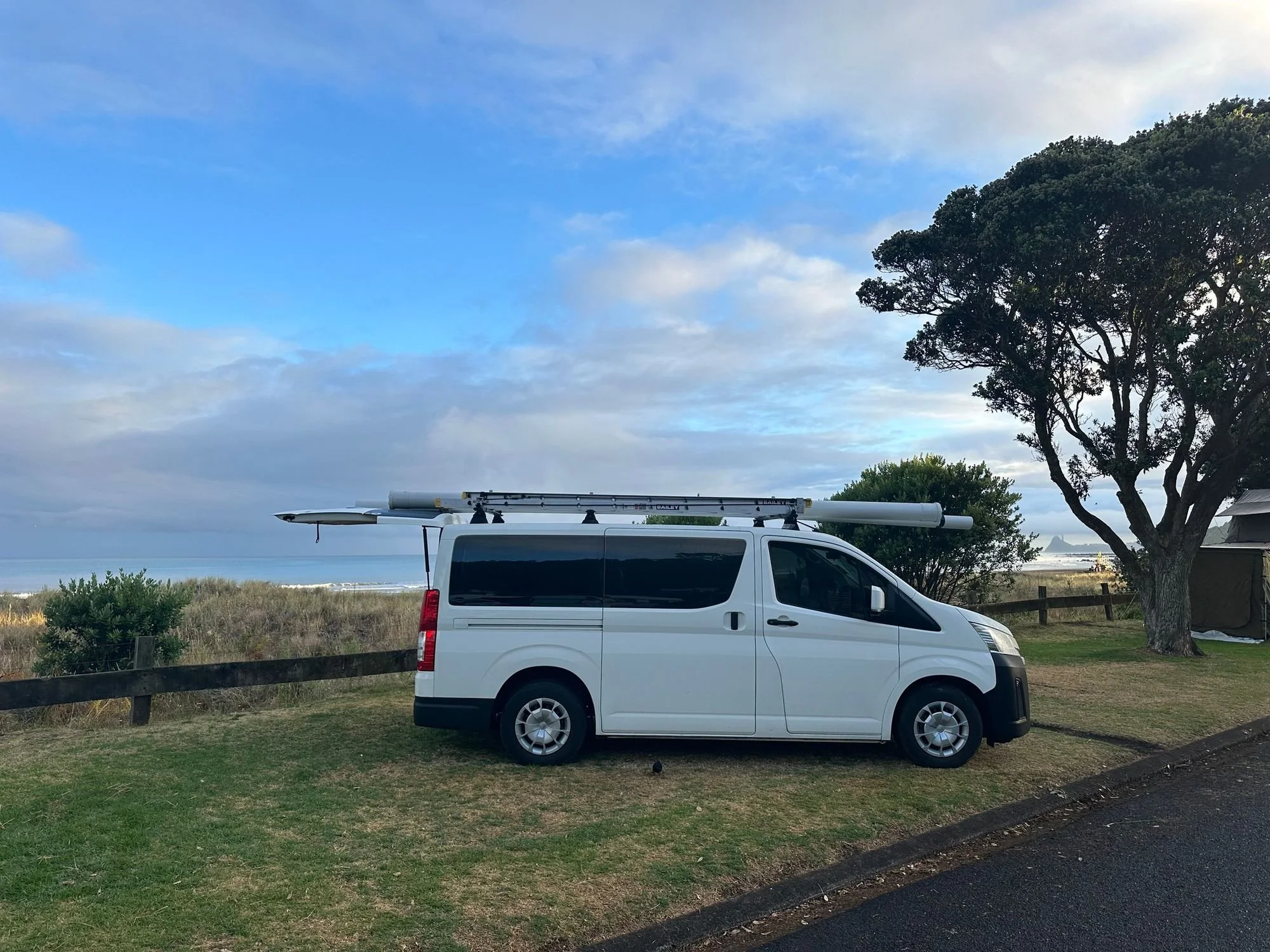 Plumbing van with pipe on top by the ocean in New Plymouth