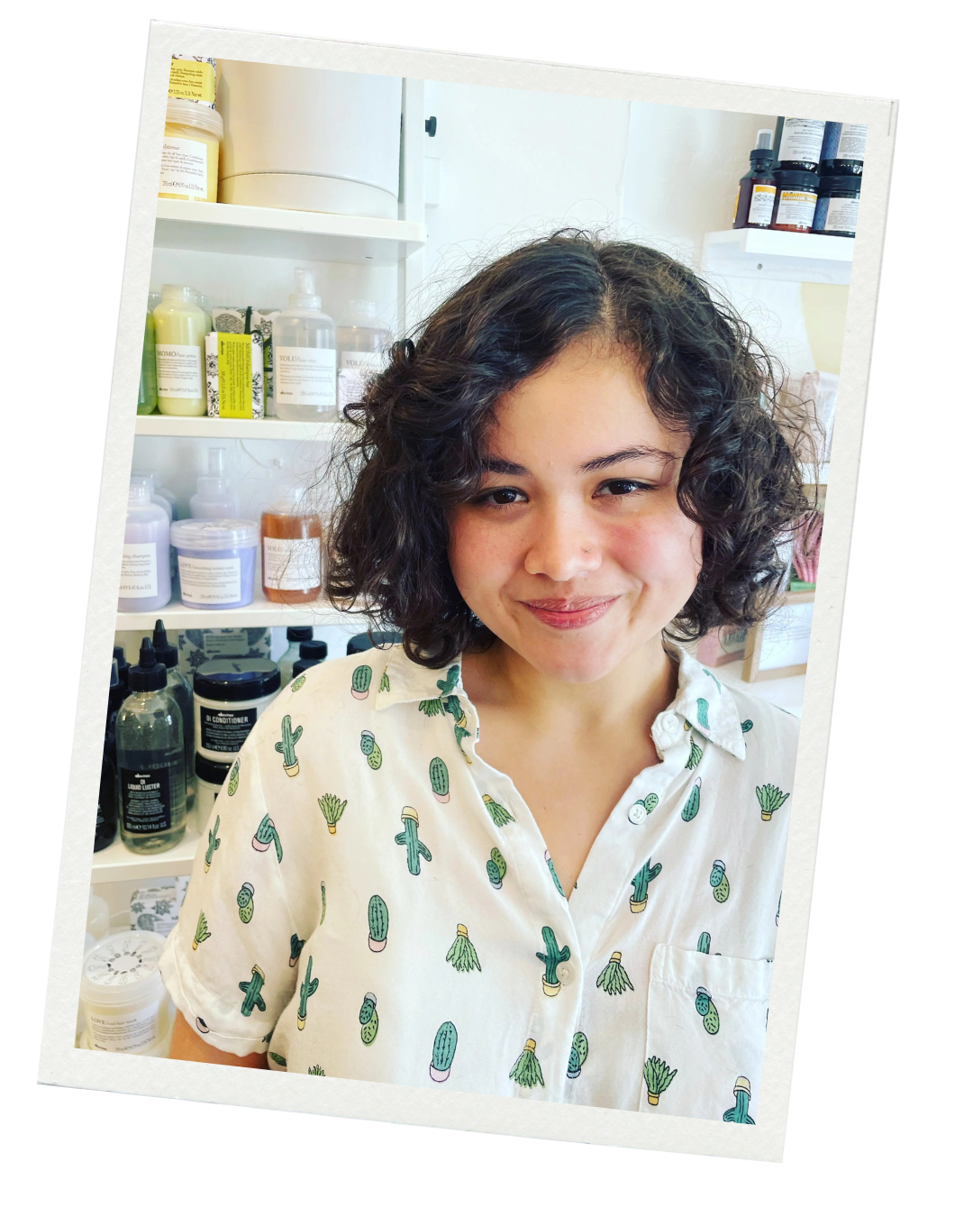 a young woman with brown, short curly chic bob