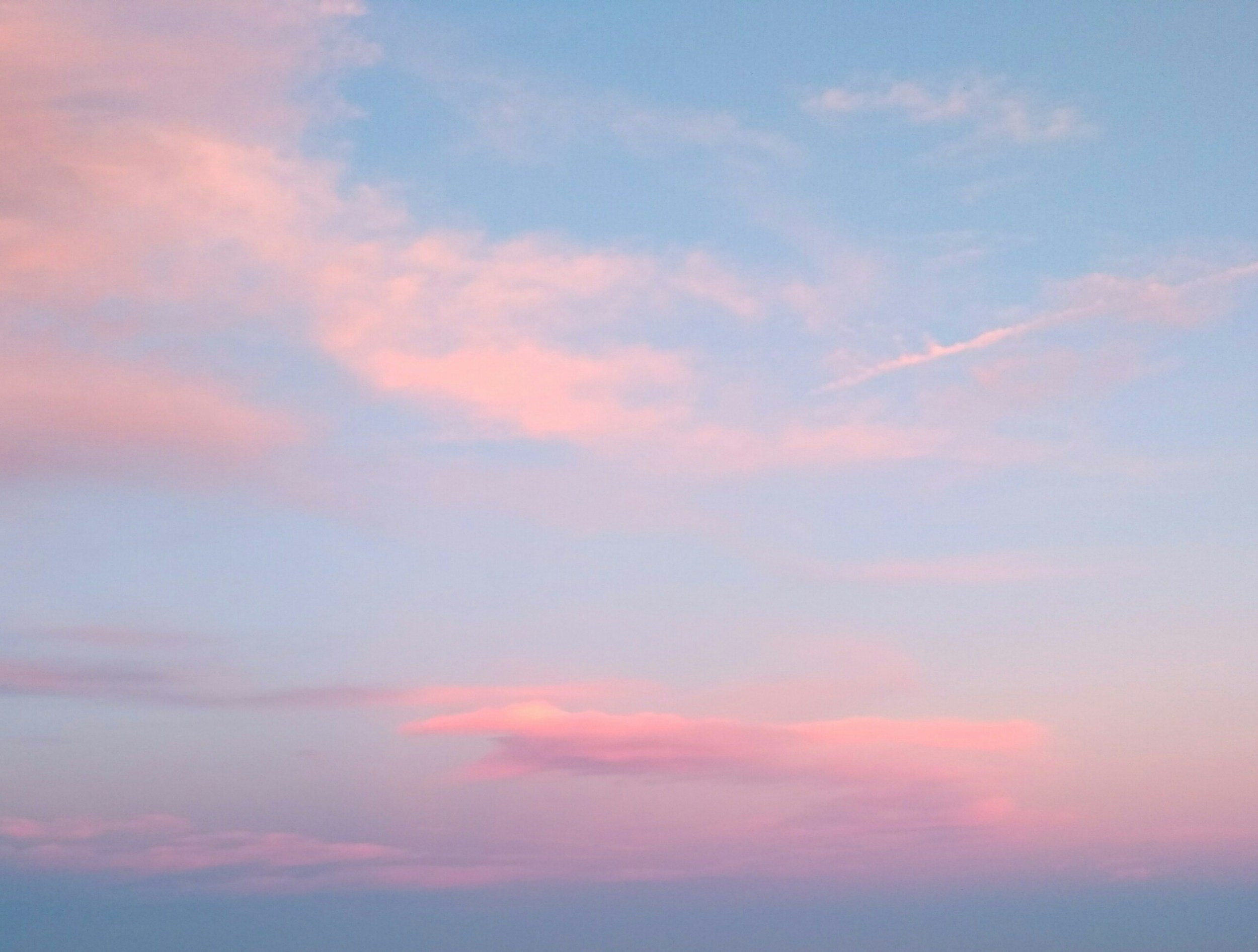 Soft pink and blue clouds in the sky during sunset or sunrise.