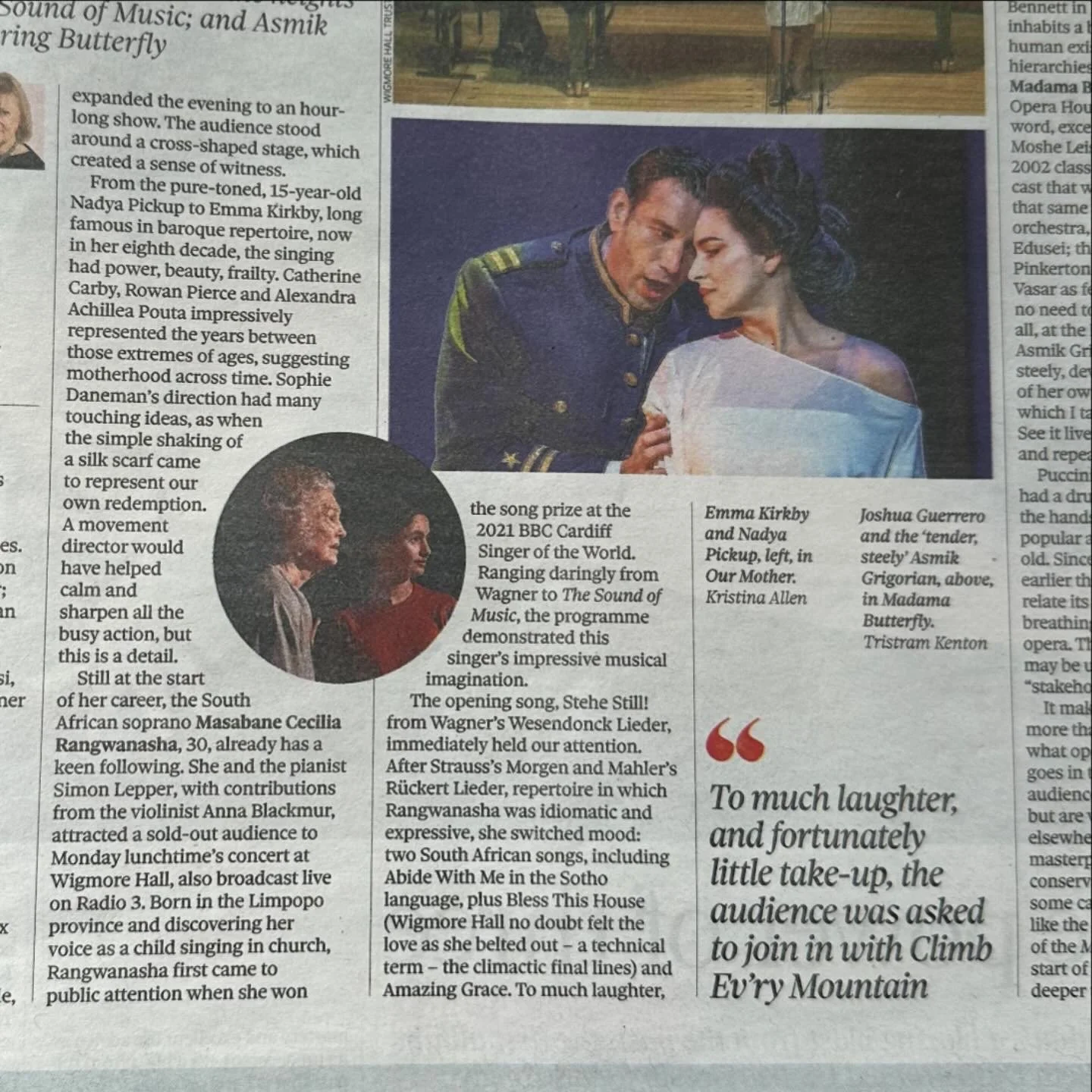 Photograph from a newspaper showing actors performing in a scene from the play Madama Butterfly, with a man in a navy uniform and a woman with dark hair in a white dress.